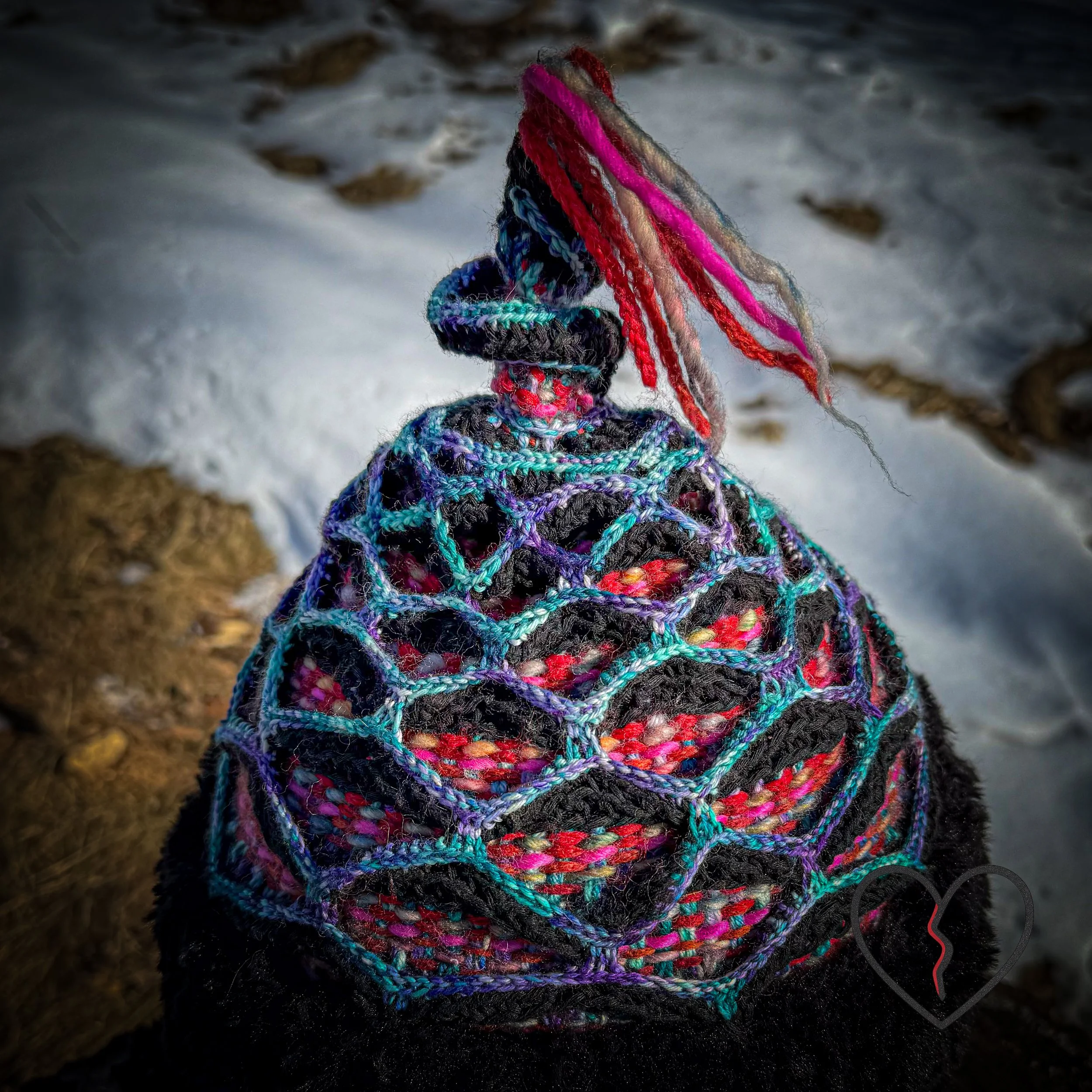 Artistic fiber headpiece featuring woven wool color, crochet lattice armor structure, and faux fur trim, symbolic of nomadic leadership.