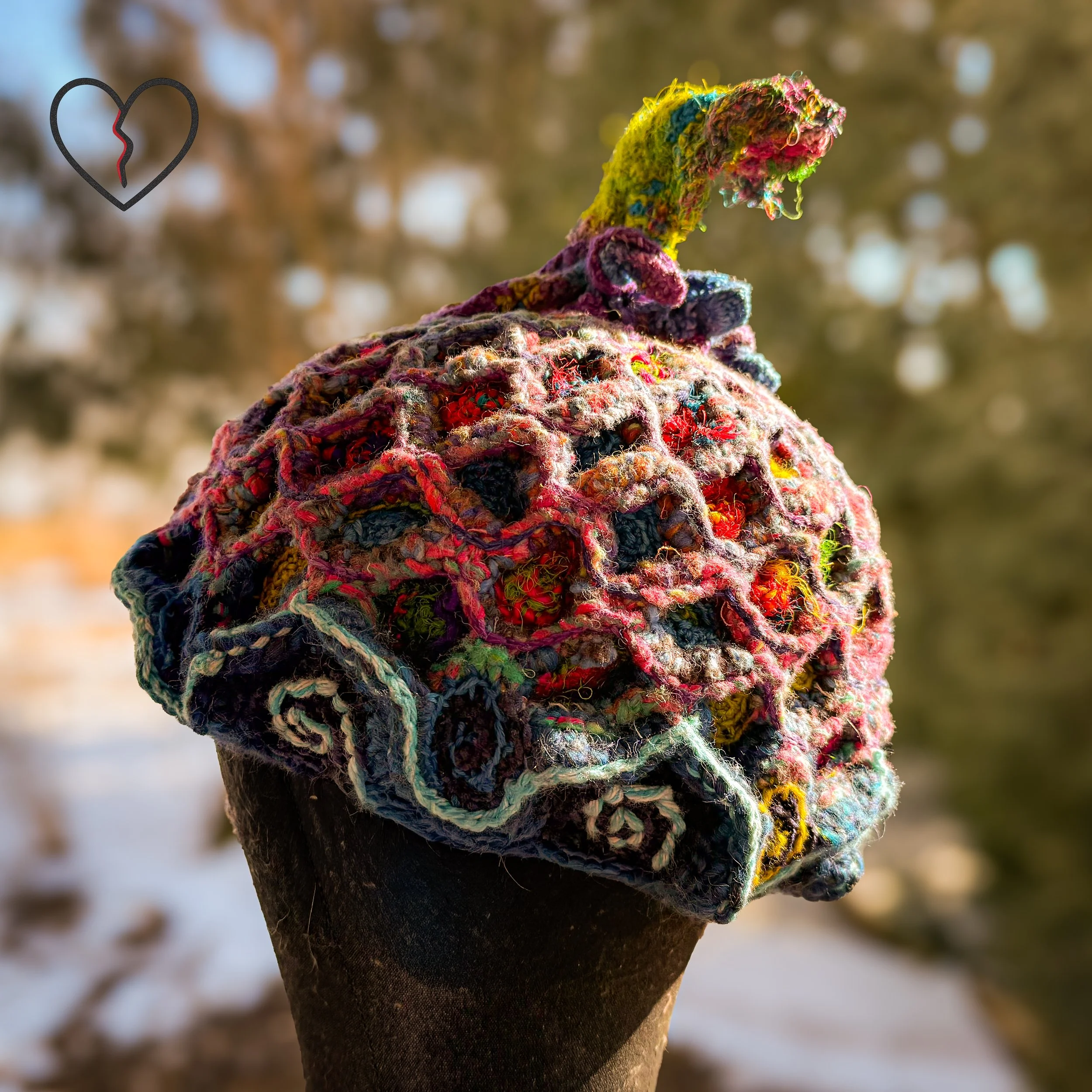 Side view showing sculptural fish body and silk tail crown