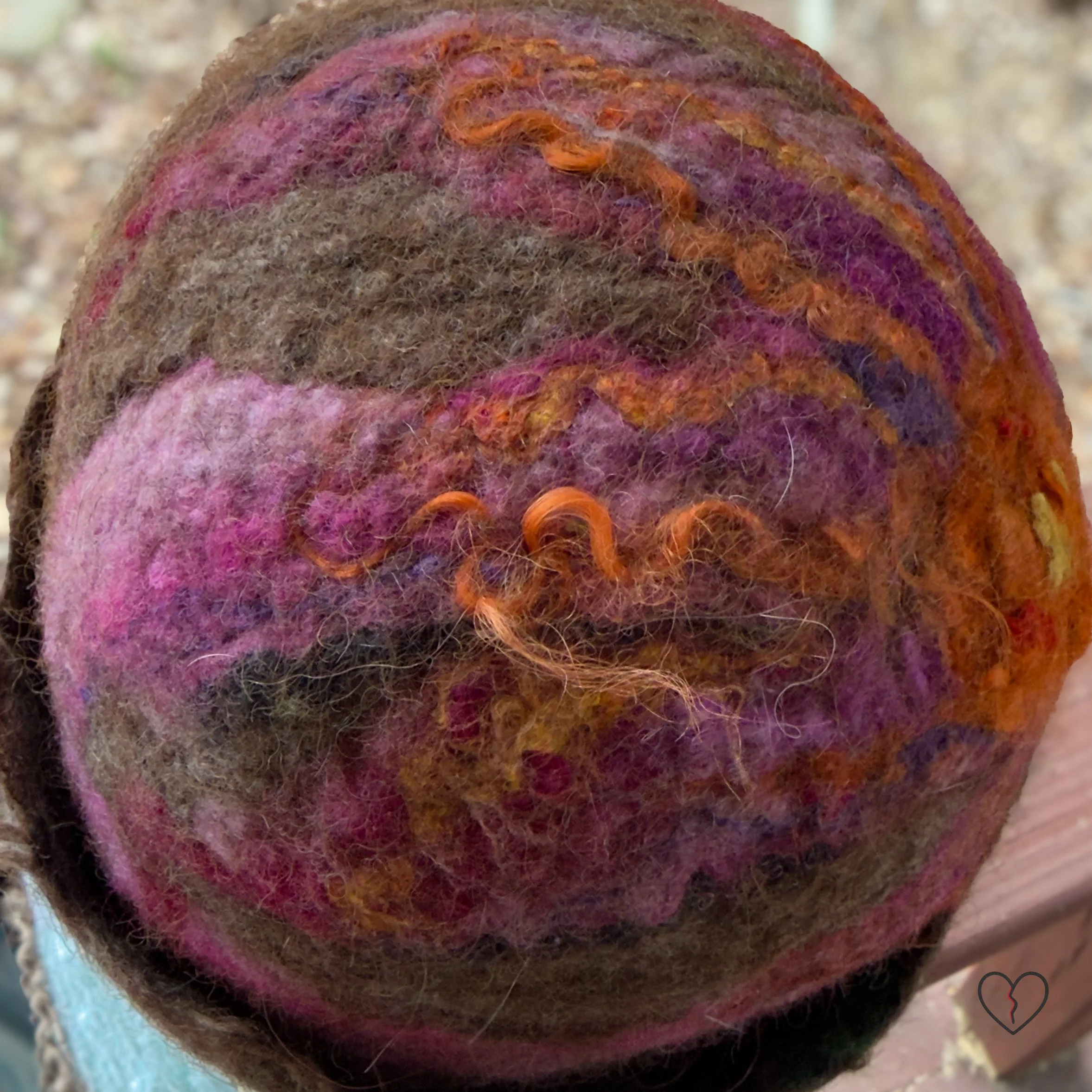 Close-up of textured brown felted wool with blended fibers