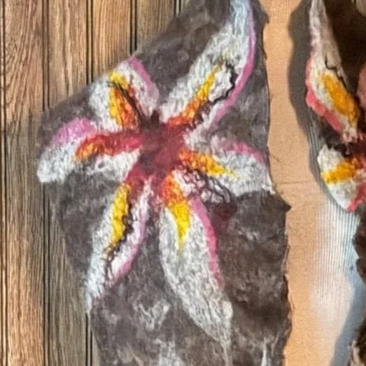 Textured felted scarf showing layered wool, silk, and sheep’s locks in floral patterns
