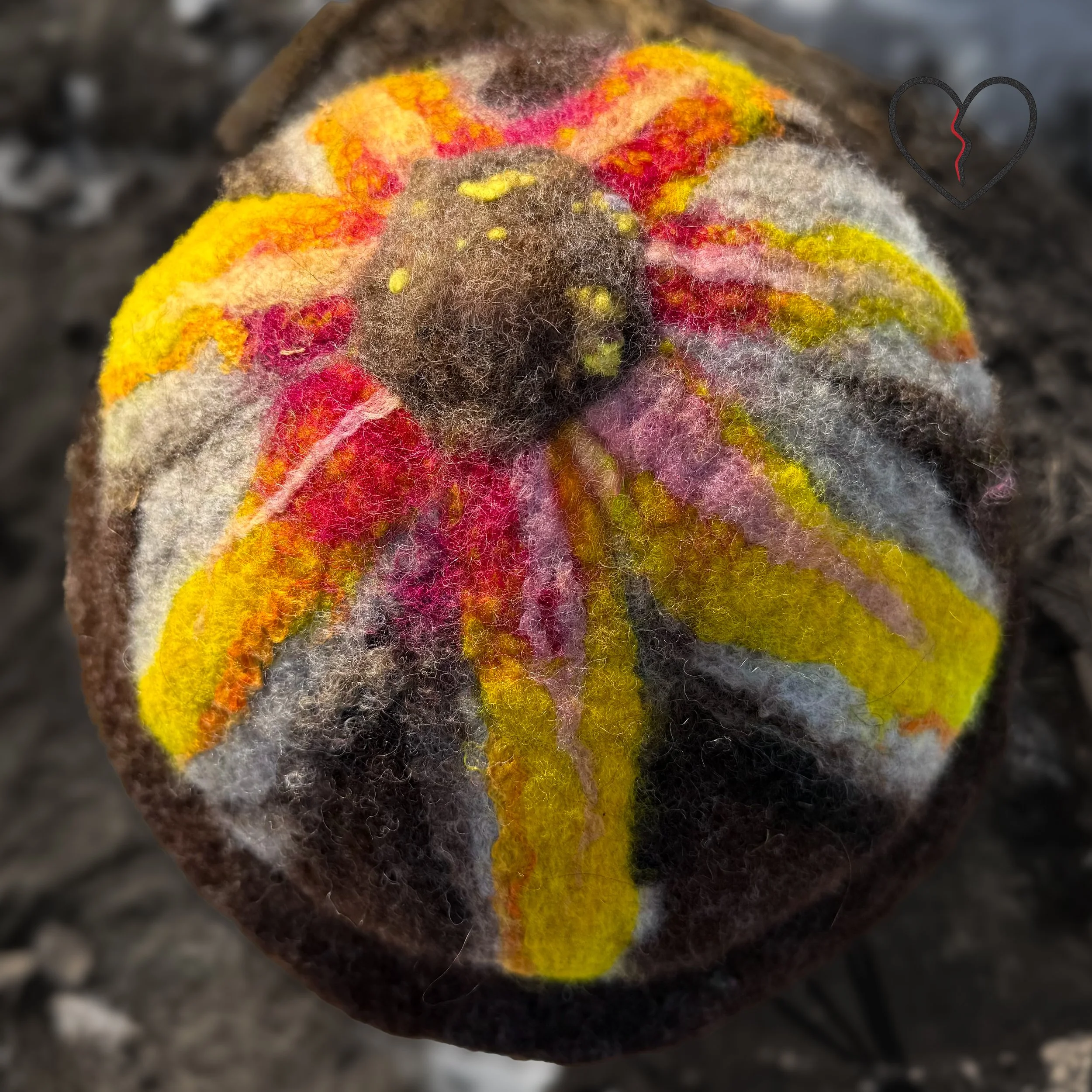 Close texture view of wet felted wool showing blended natural fibers and sculpted surface.