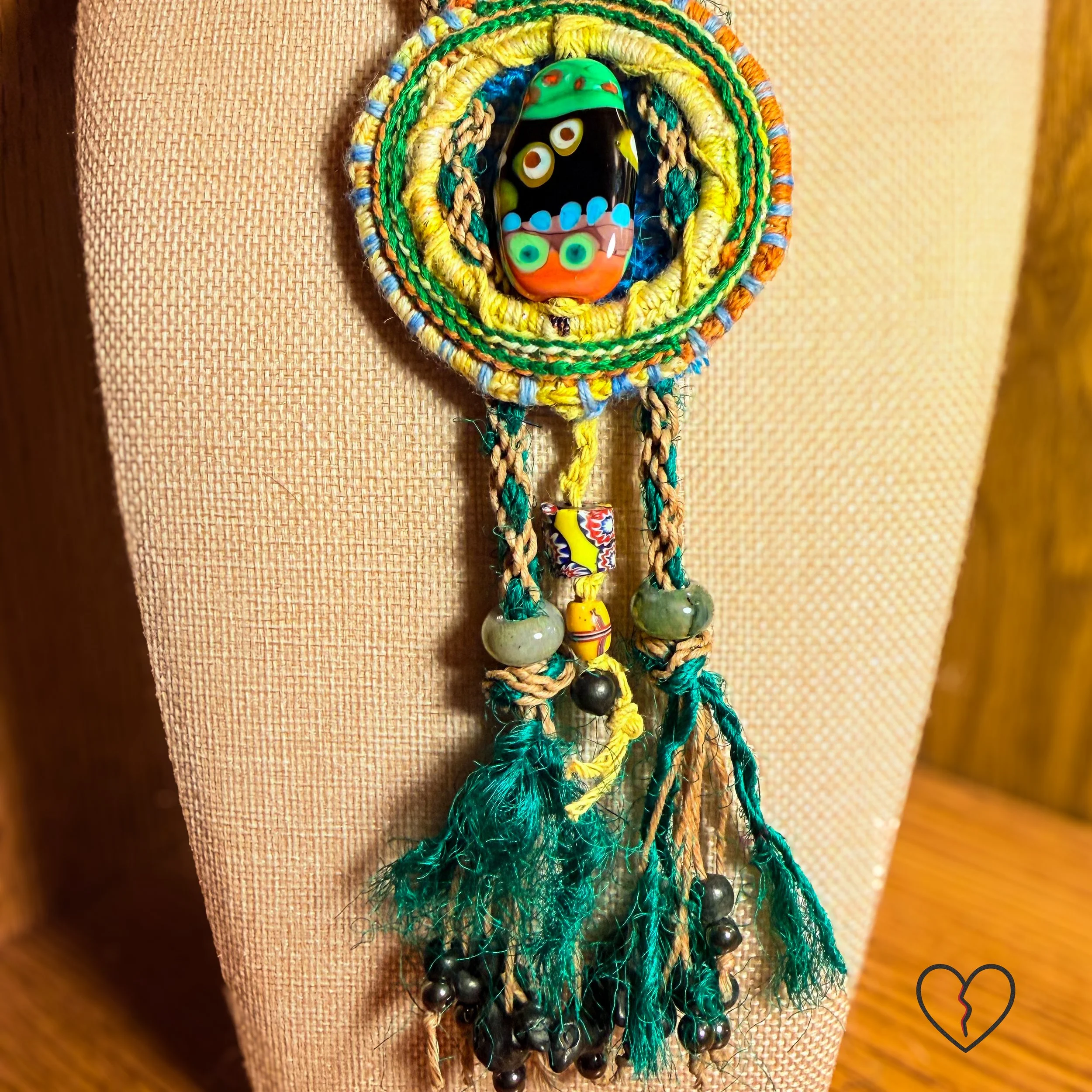 Detail of serpentine, trade beads, and tassel strands