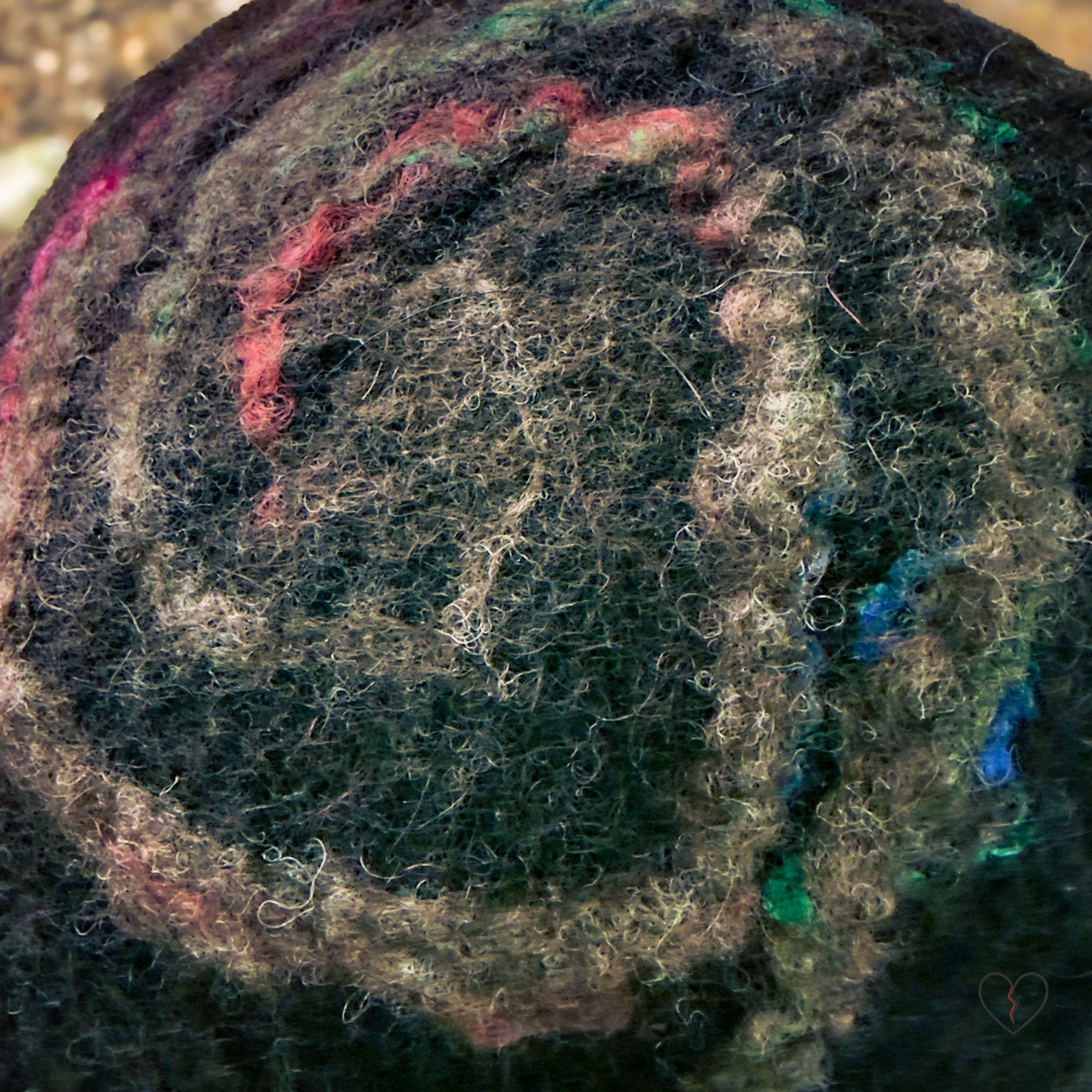 Artist wearing brown spiral felt hat in a natural outdoor setting