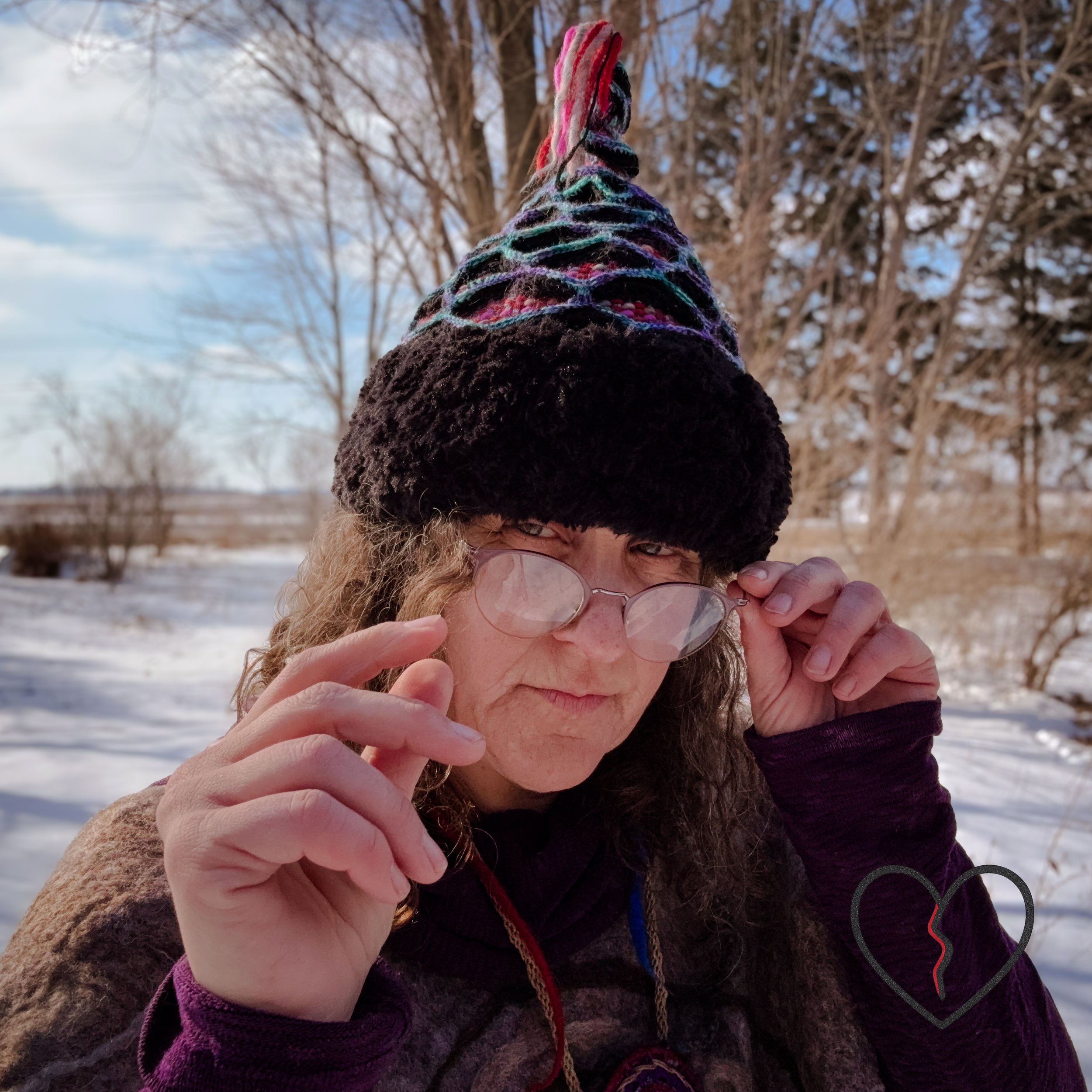 Handwoven and freeform crochet sculptural headpiece with lattice structure, woven wool interior, faux fur brim, and spike, inspired by Mongolian war helmets.