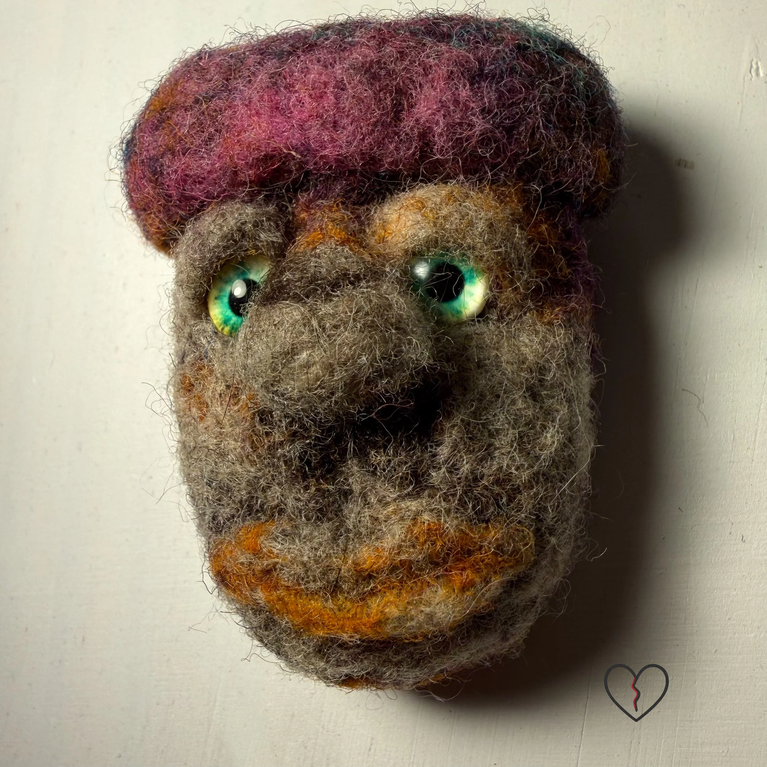 Handmade needle felted wool art pins arranged as a small collection, each approximately two inches square, featuring sculptural forms, layered fiber textures, and earthy, autumn-toned colors.