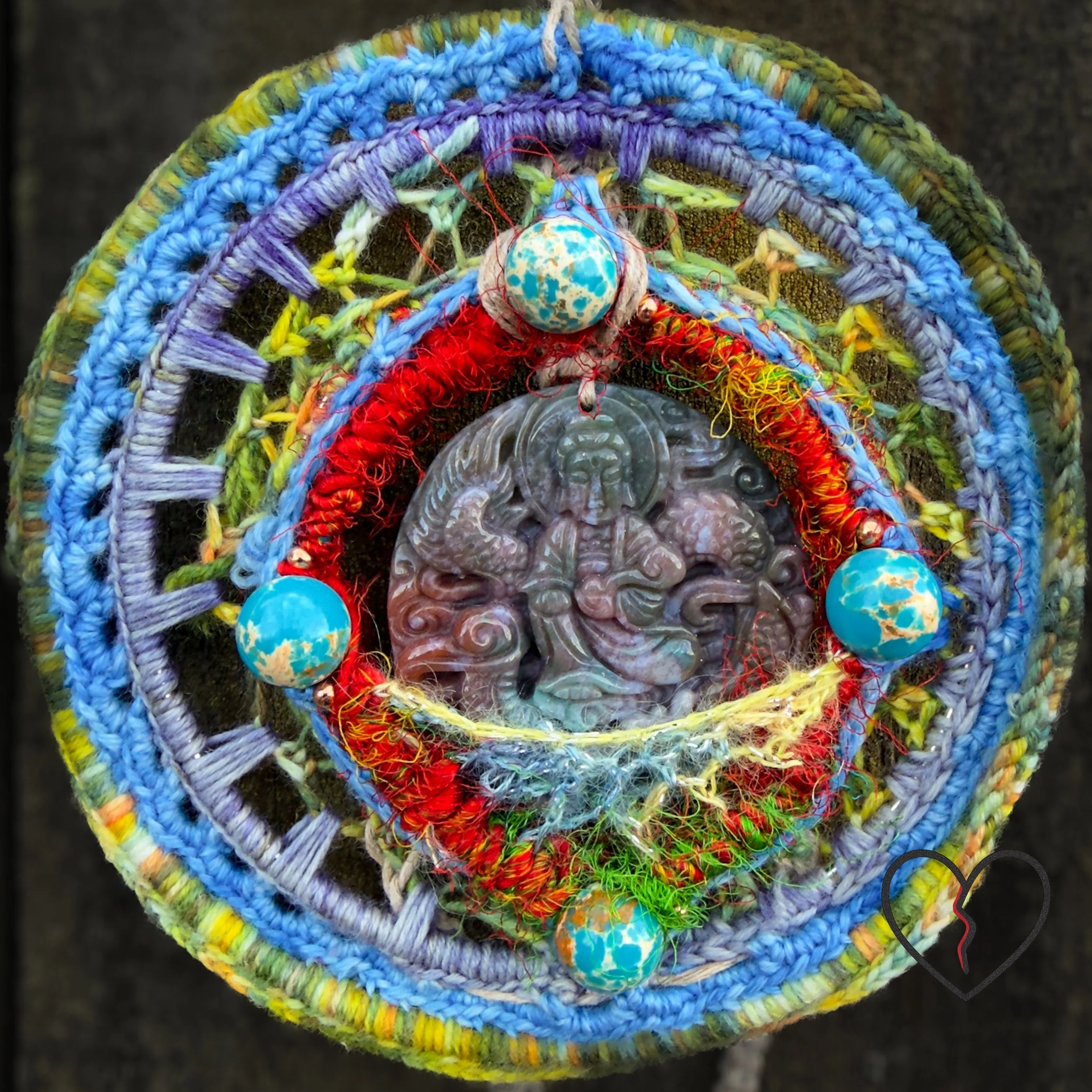 Handmade freeform crochet Dreamcatcher featuring a carved jade Buddha, painted howlite beads, silk, wool, and hemp. One-of-a-kind fiber art wall hanging.
