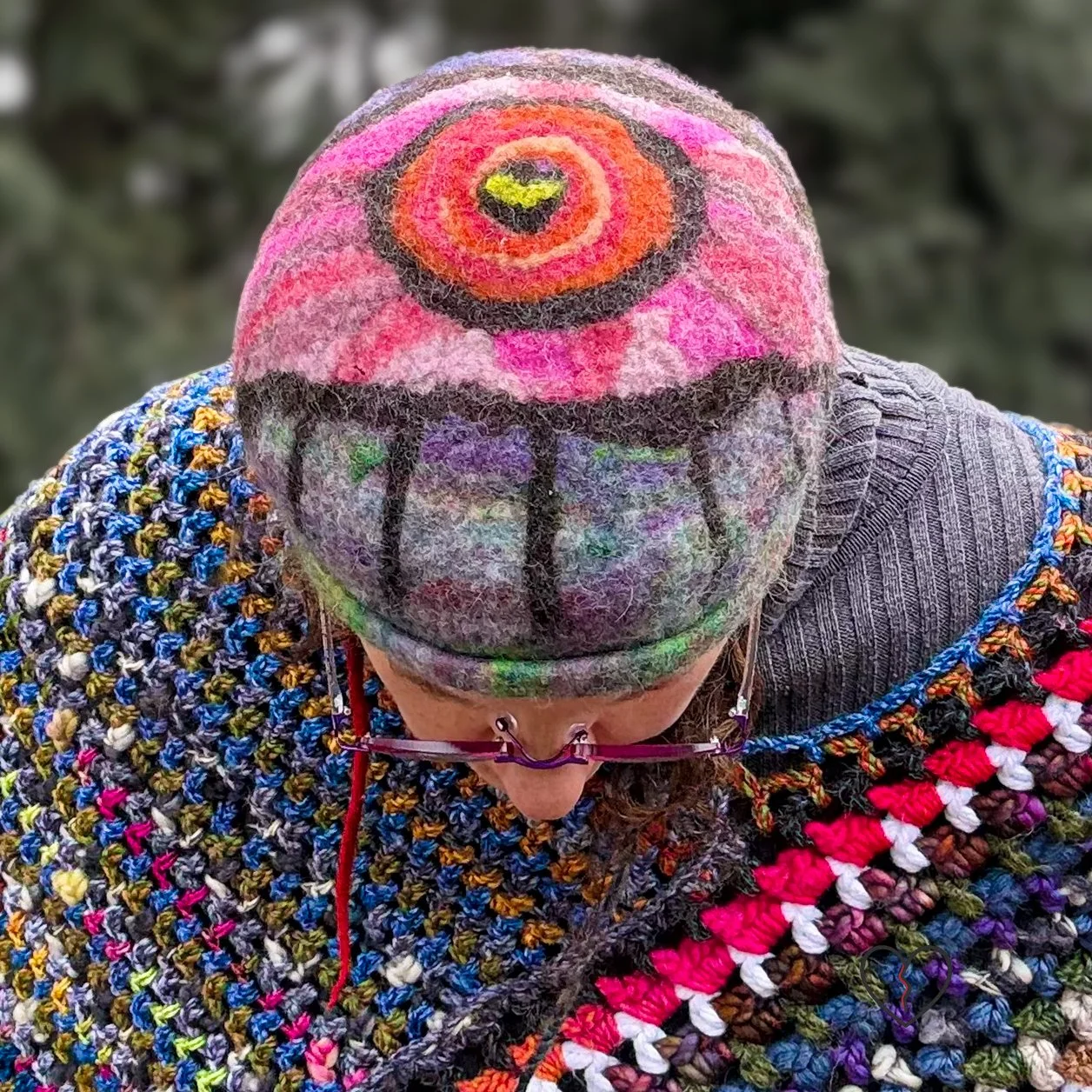 Hand-felted wool hat with a symbolic eye and celestial purple-blue design.