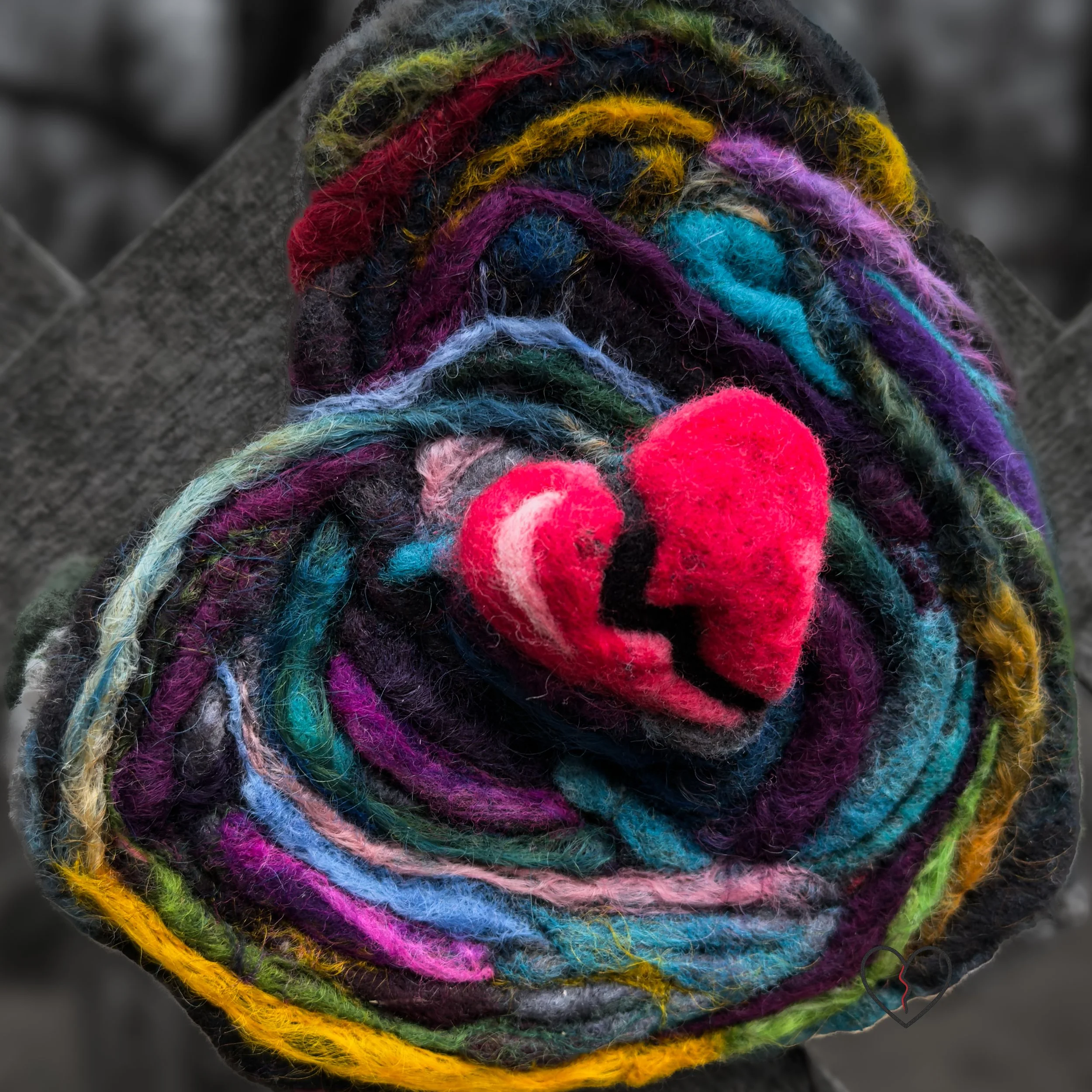 Needle-felted wool broken heart emerging from melting heart