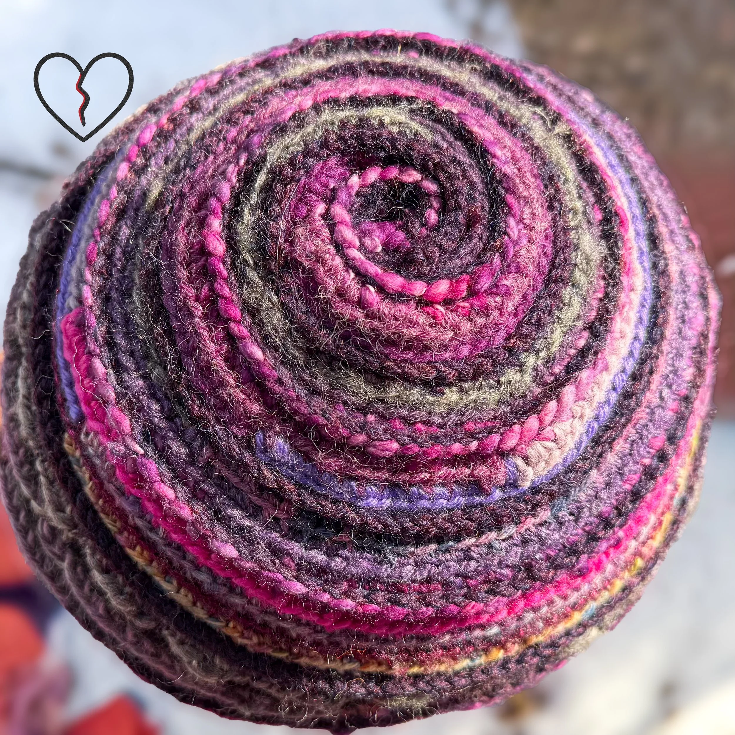 Close view of layered art yarn textures in Purple Tornado freeform crochet hat, one of a kind wearable fiber art.