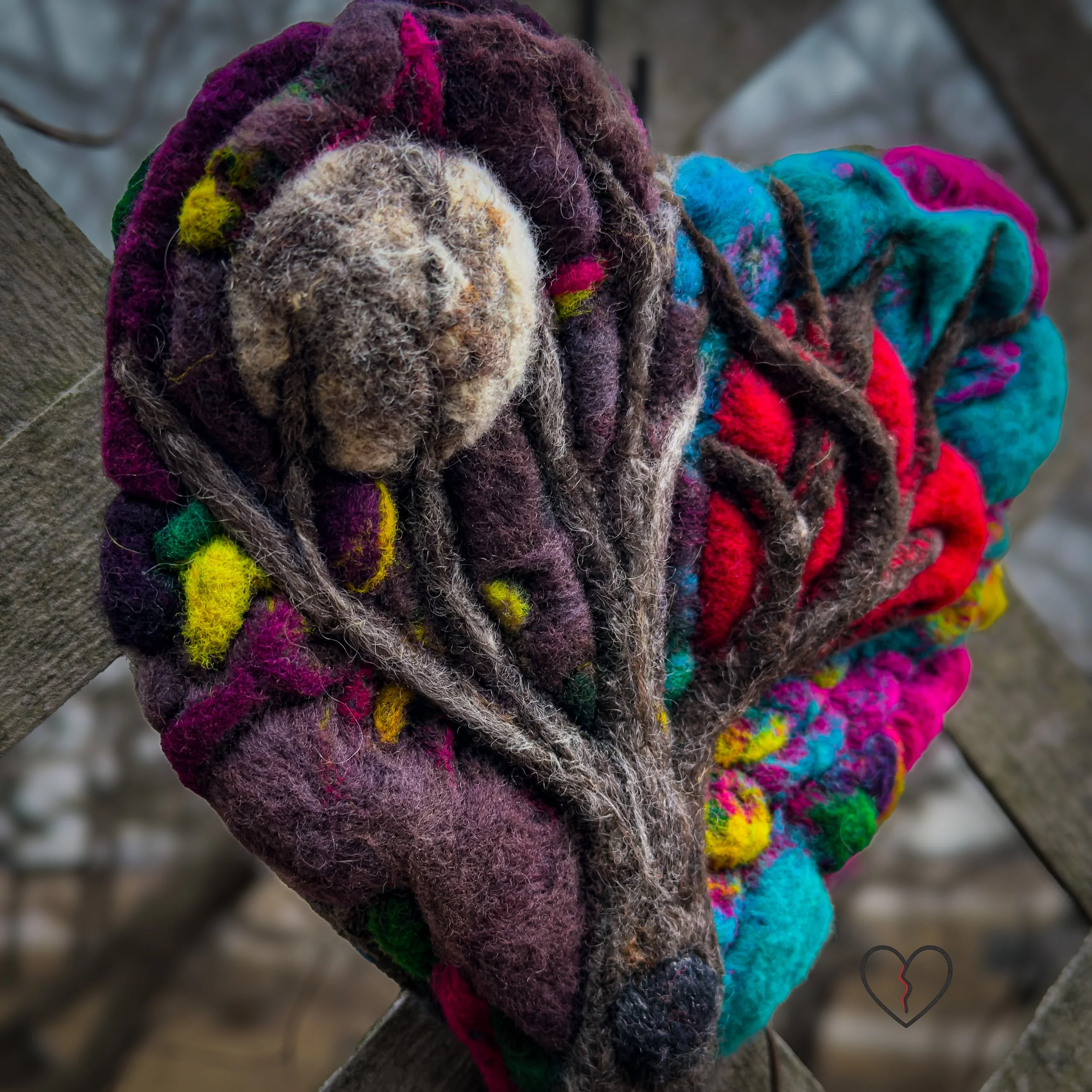 Symbolic wool wall art featuring moon and ruptured heart