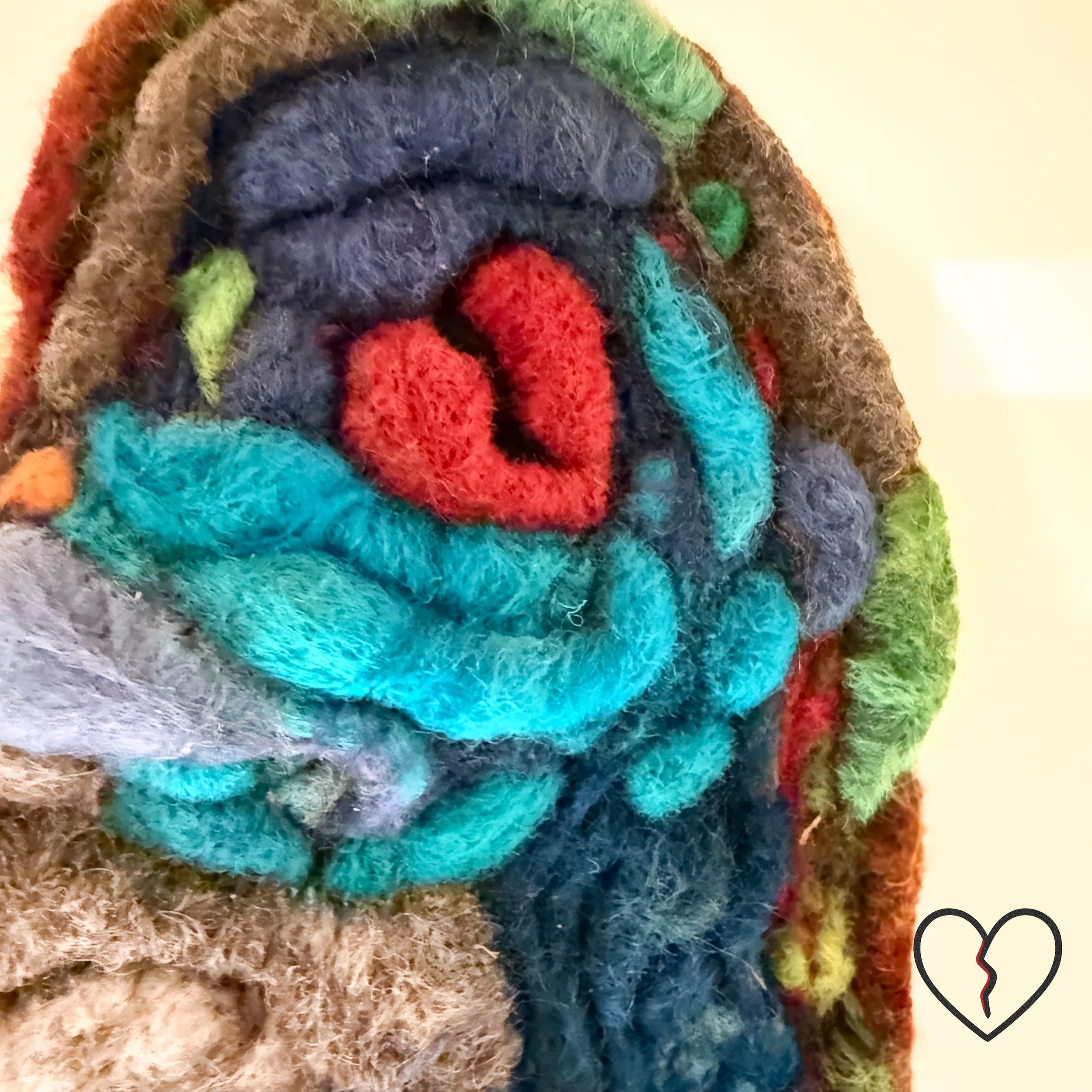The Child Within reveals the pure inner spirit inside a scarred heart. Symbolic needle-felted wool sculpture exploring resilience, healing, and transformation. Visit KristiYapp-woolalchemist.com