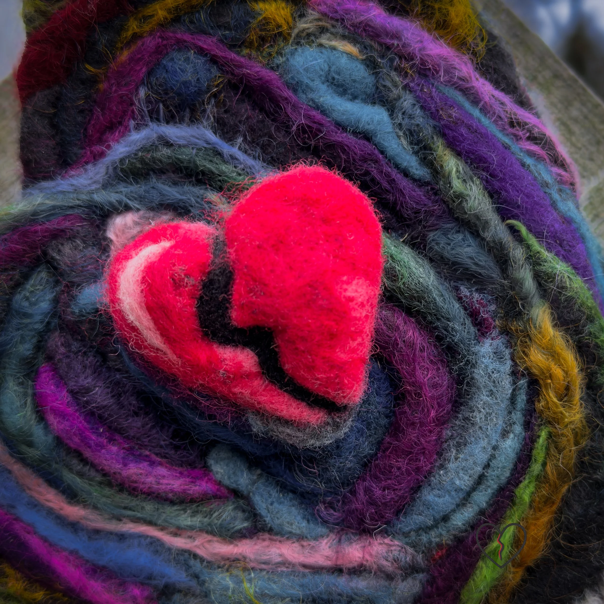 Side view of dimensional needle-felted wool heart