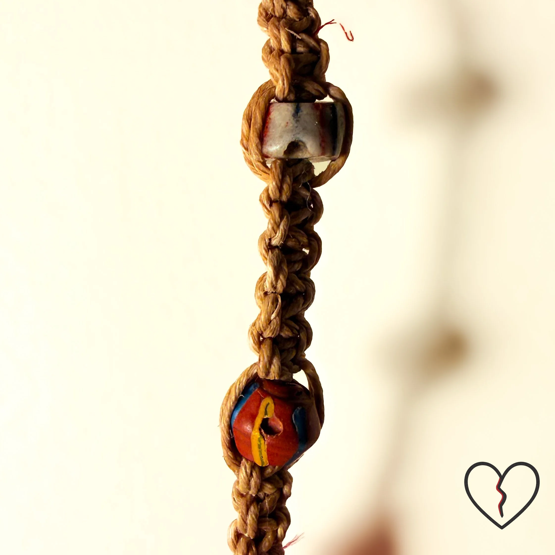 Hand crocheted wool and sari silk dreamcatcher with reclaimed prism and African trade beads representing protection, journey, and illumination. One of a kind fiber wall hanging by Kristi Yapp, 2024.