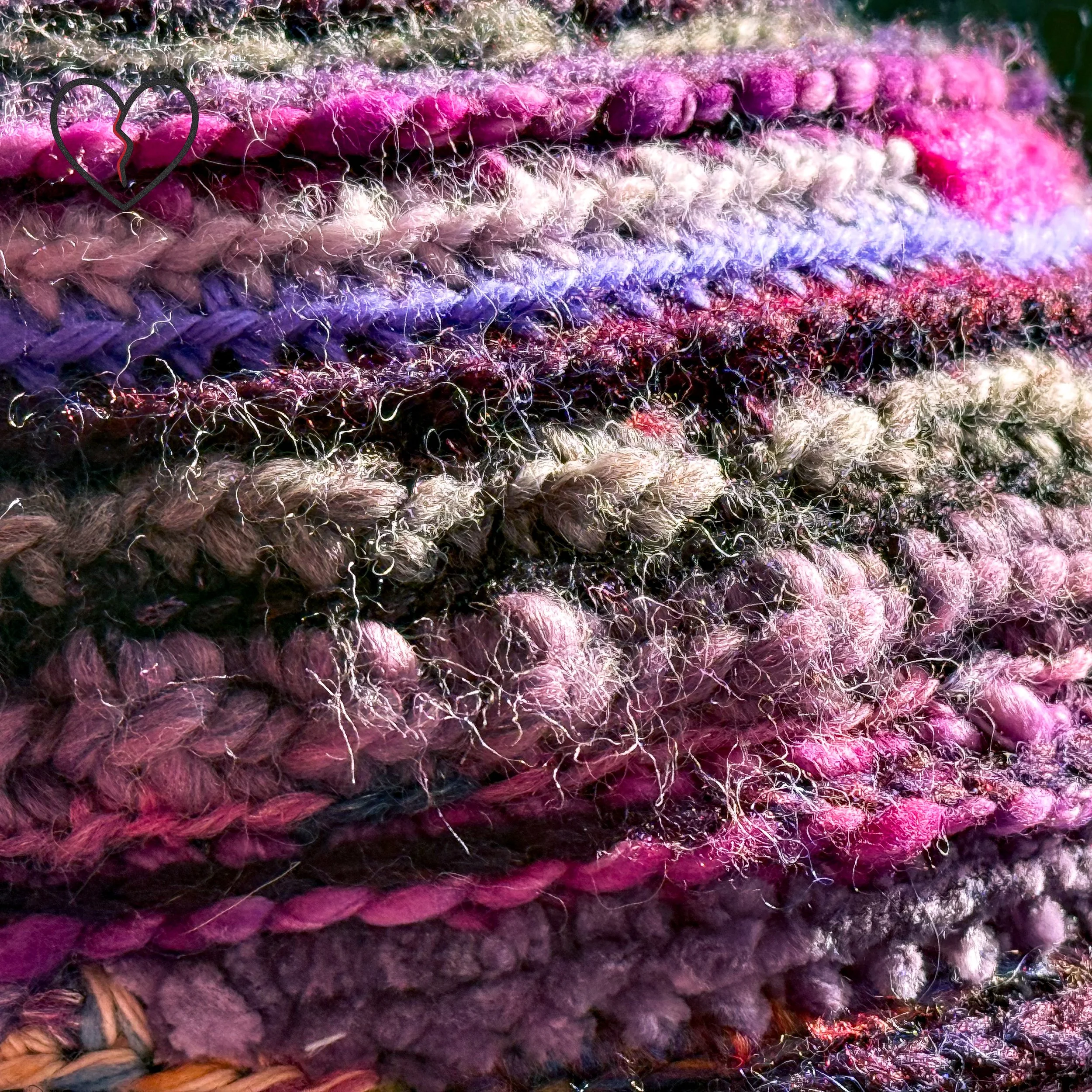 Side view of Purple Tornado freeform crochet hat showing layered spiral construction and dimensional fiber texture.