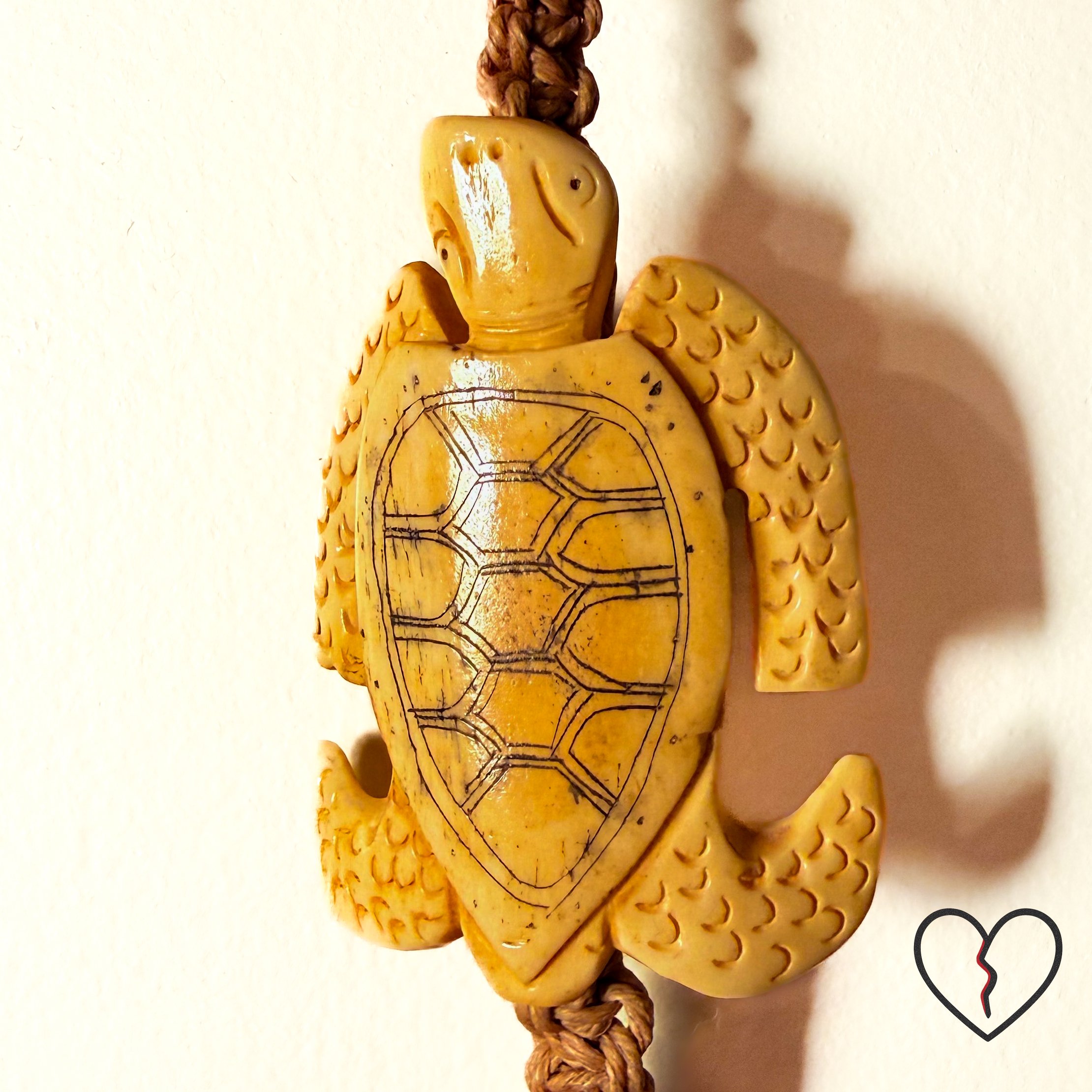 Macrame cord with protective trade bead and structural knot work.