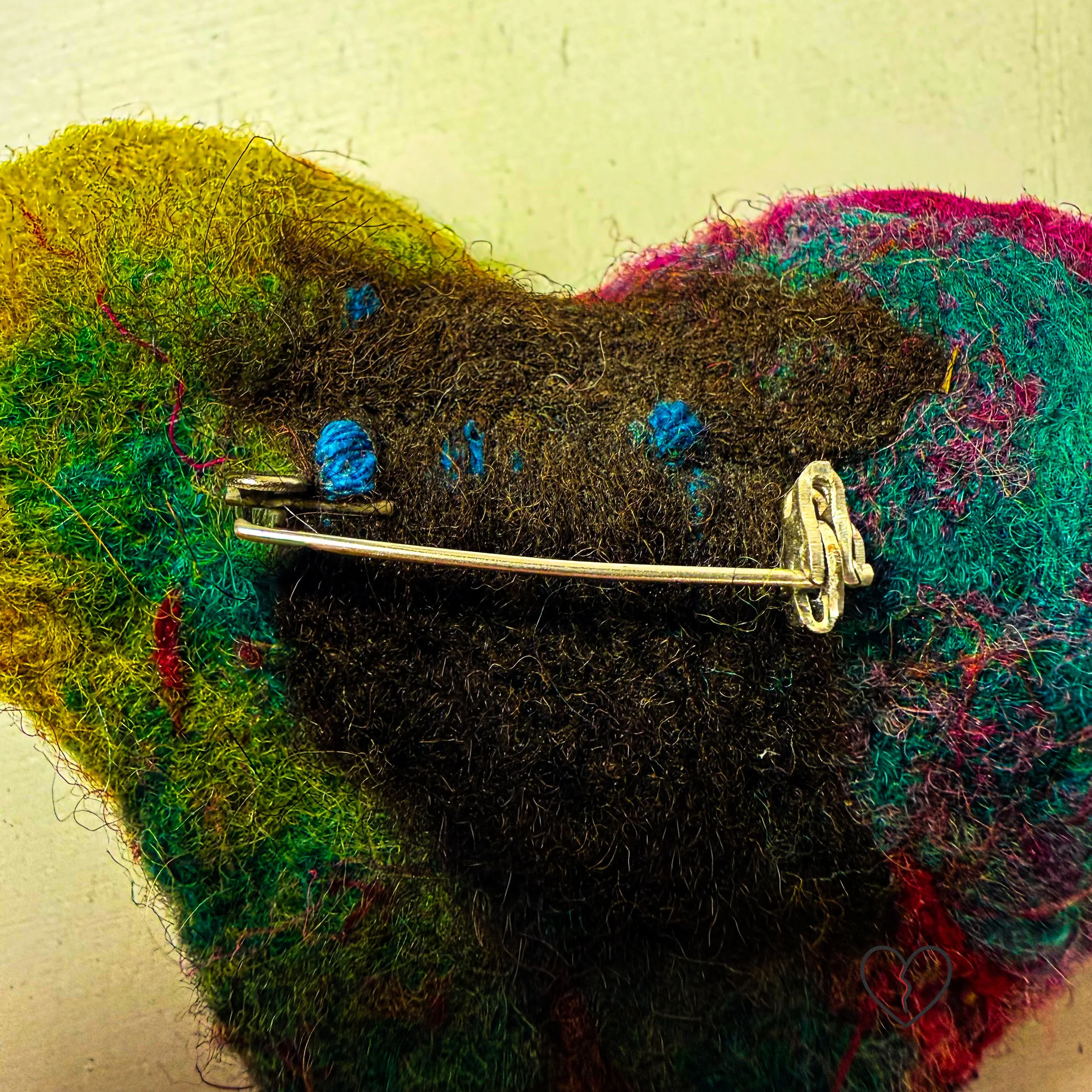 Handmade needle felted wool art pin by fiber artist Kristi Yapp. One of a kind, lightweight, and sculptural wearable fiber art.
