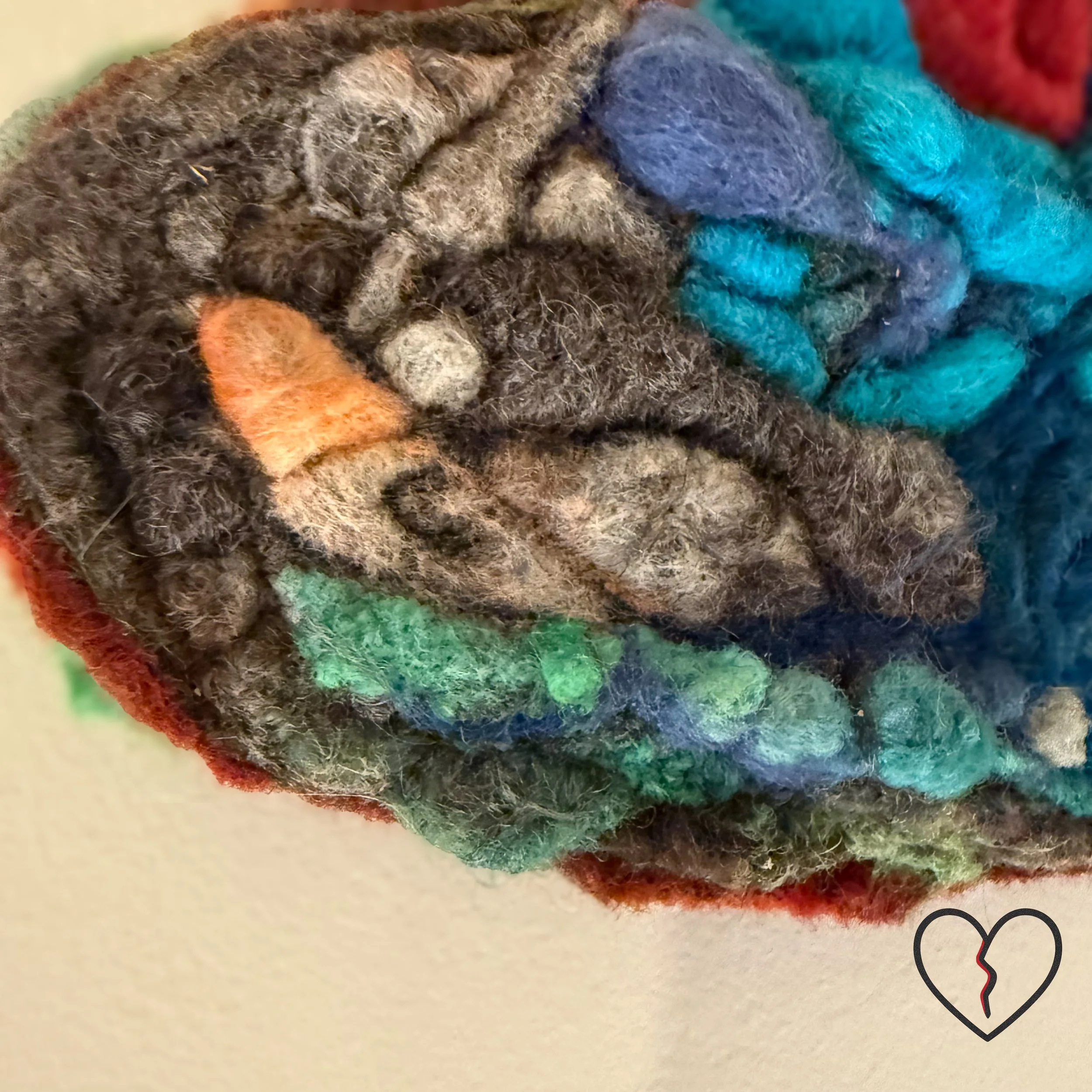 From the Broken Heart Series, The Child Within expresses healing emerging from fracture through symbolic wool fiber sculpture. Visit KristiYapp-woolalchemist.com