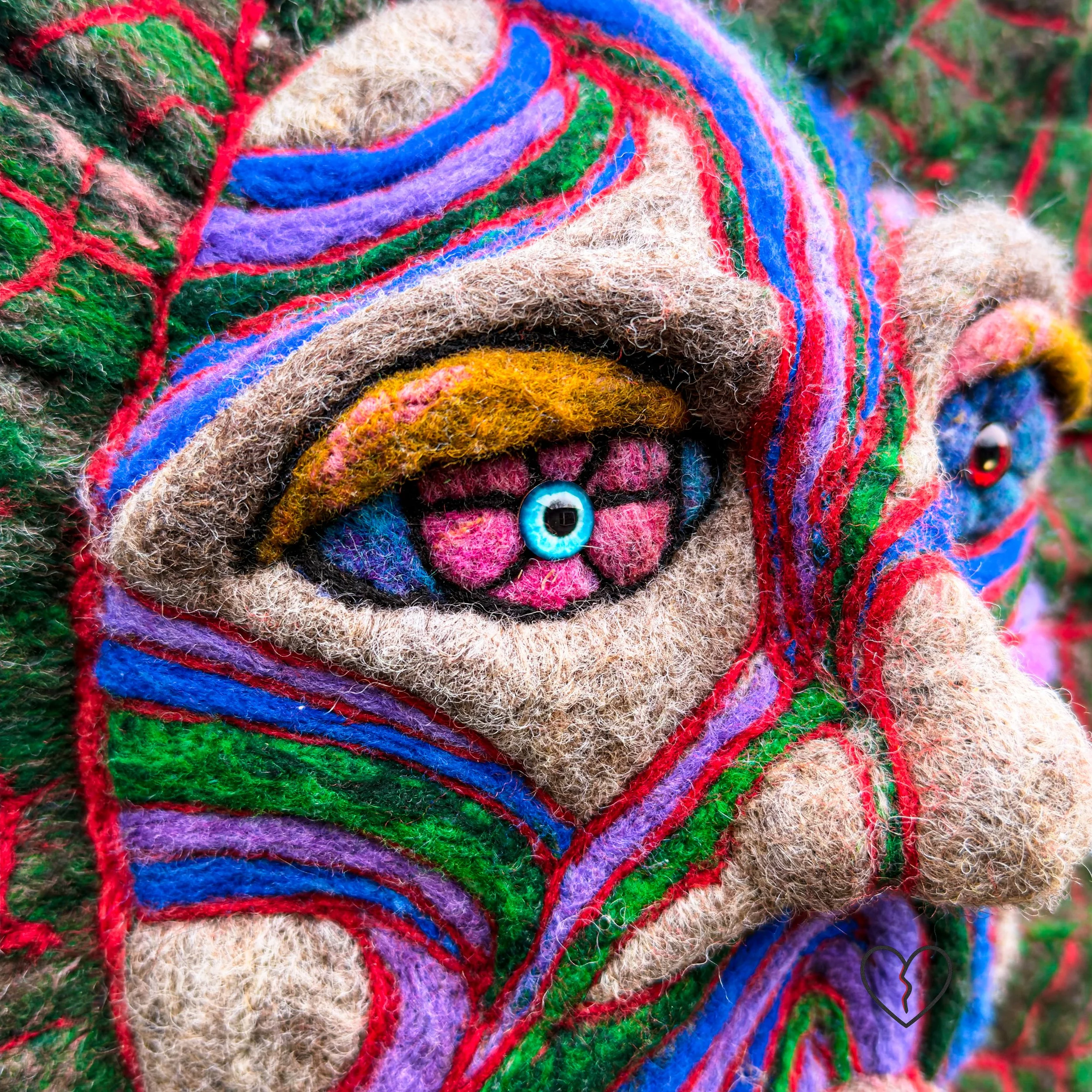 Detail of fading color and surface texture in wool sculpture