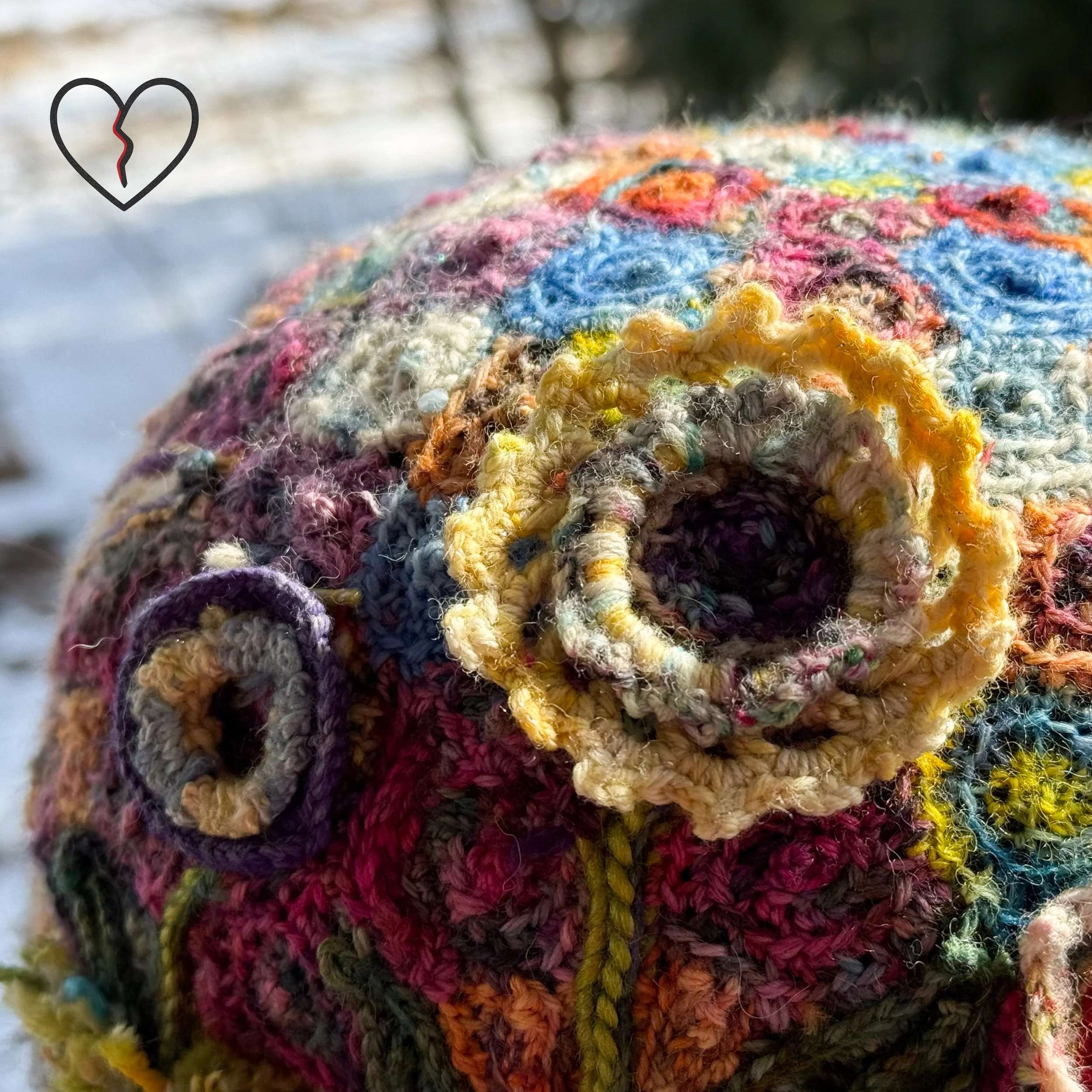 Extreme detail of African trade bead focal point surrounded by radiating stitched sun