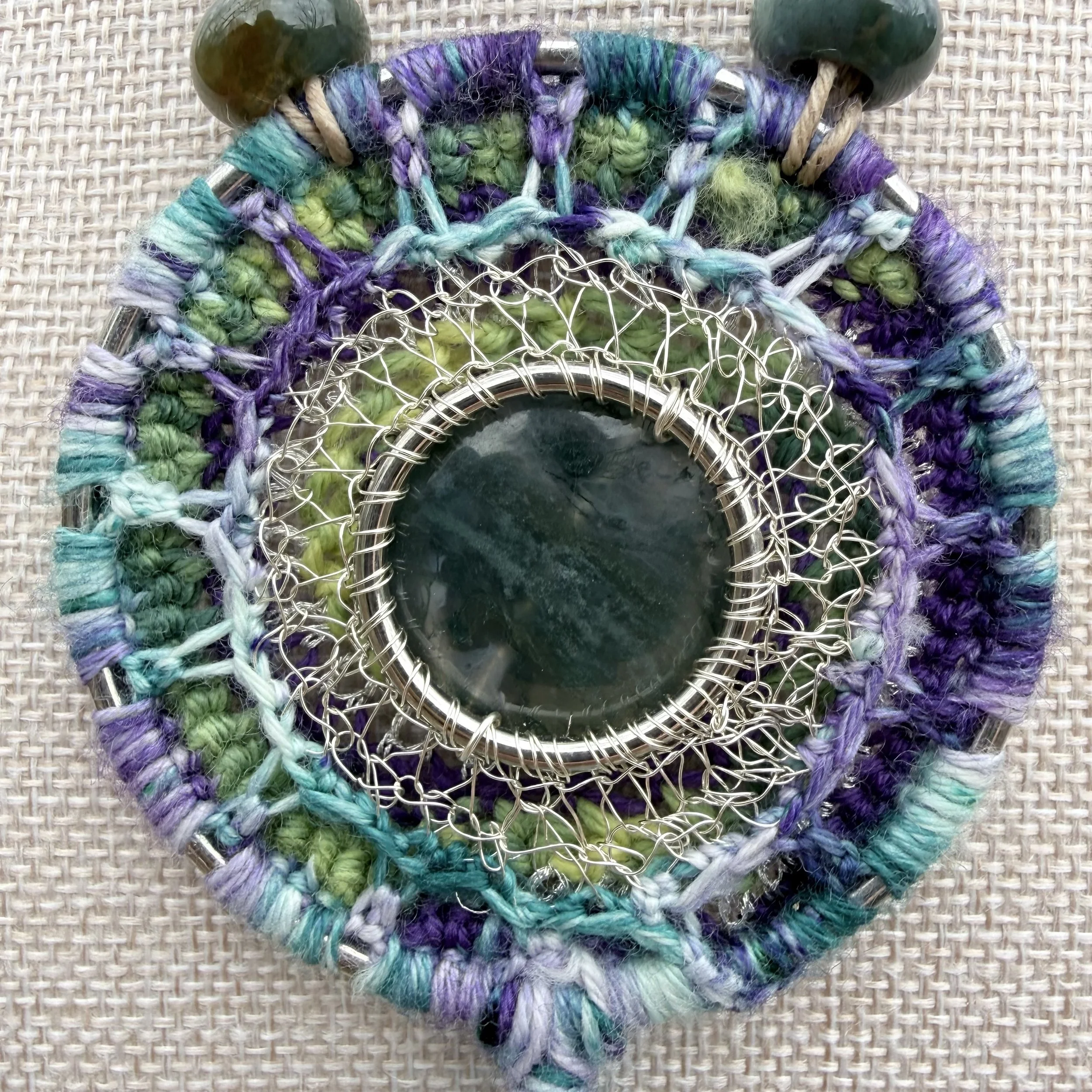 Spring Forest Amulet with moss agate center, crocheted wool and wire setting, serpentine beads