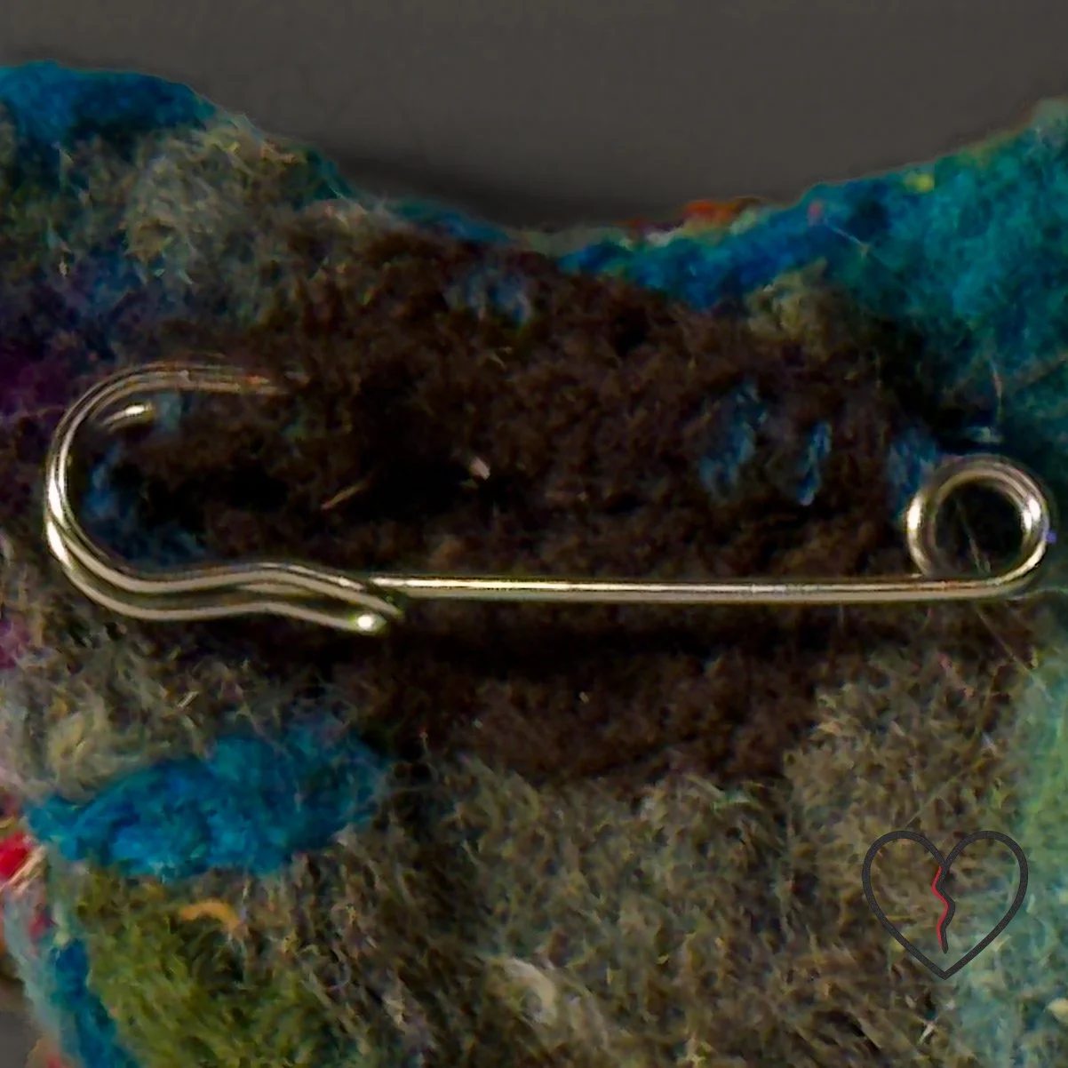 Detail view of layered wool textures and visible fractures in the heart