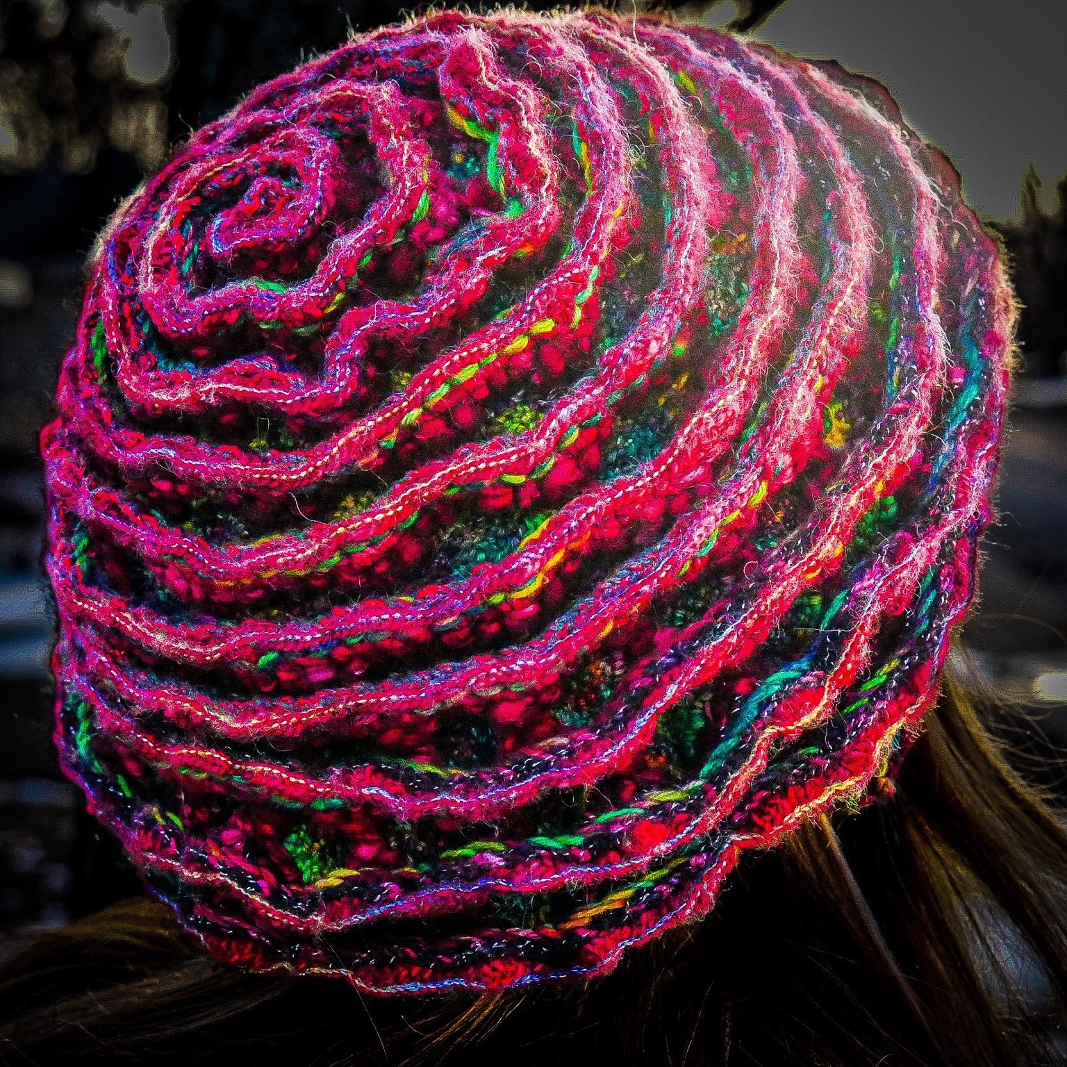 Rear view reveals the complete spiral construction of The Cosmic Rose, emphasizing its continuous, uninterrupted crochet form and structural integrity.