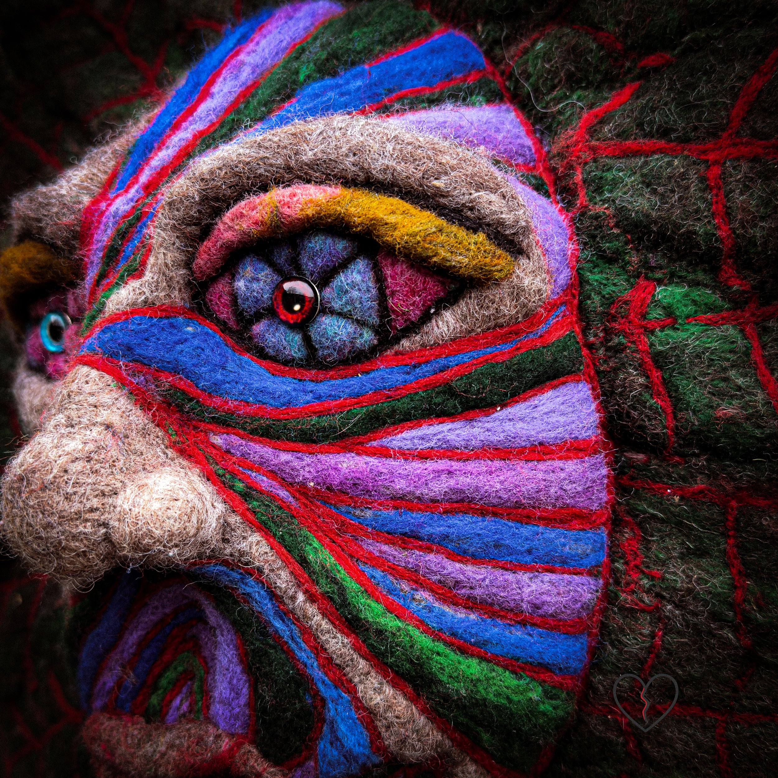 Handcrafted wool spirit art representing ecological endurance
