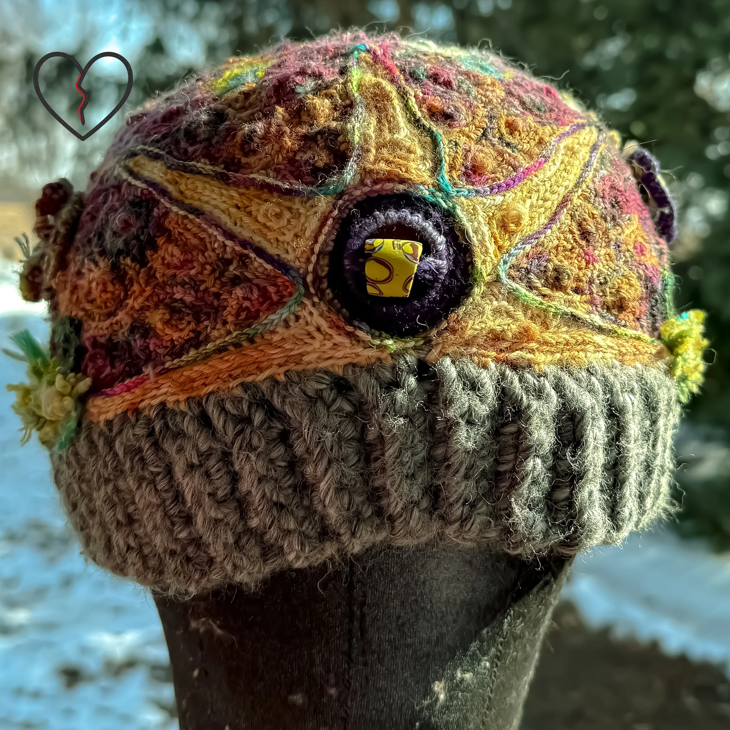 Side detail showing layered stitch architecture, symbolic sun form, and dense micro crochet texture