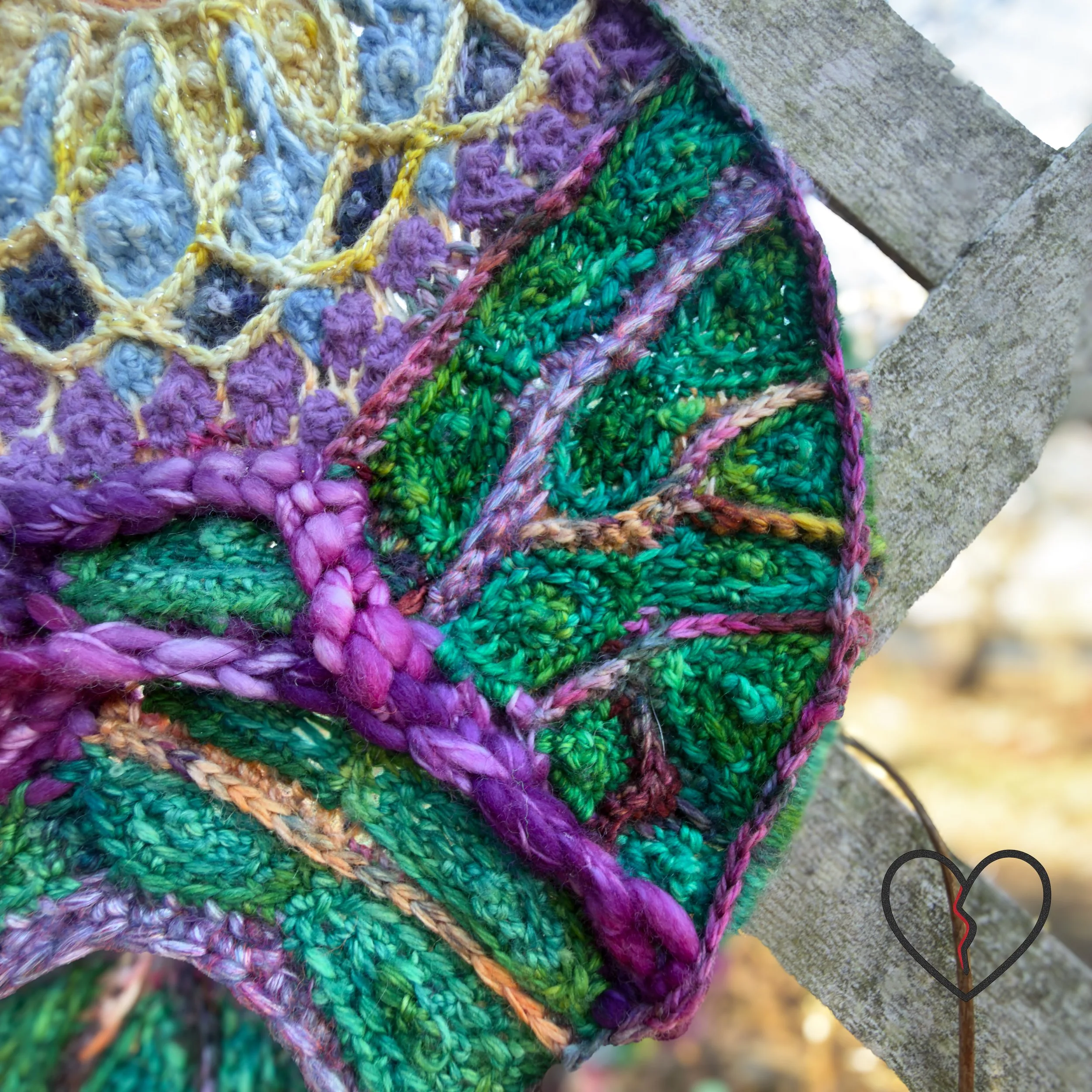 Close-up of braided purple wool yarn integrated into freeform crochet stitches, highlighting texture and hand-crafted construction.