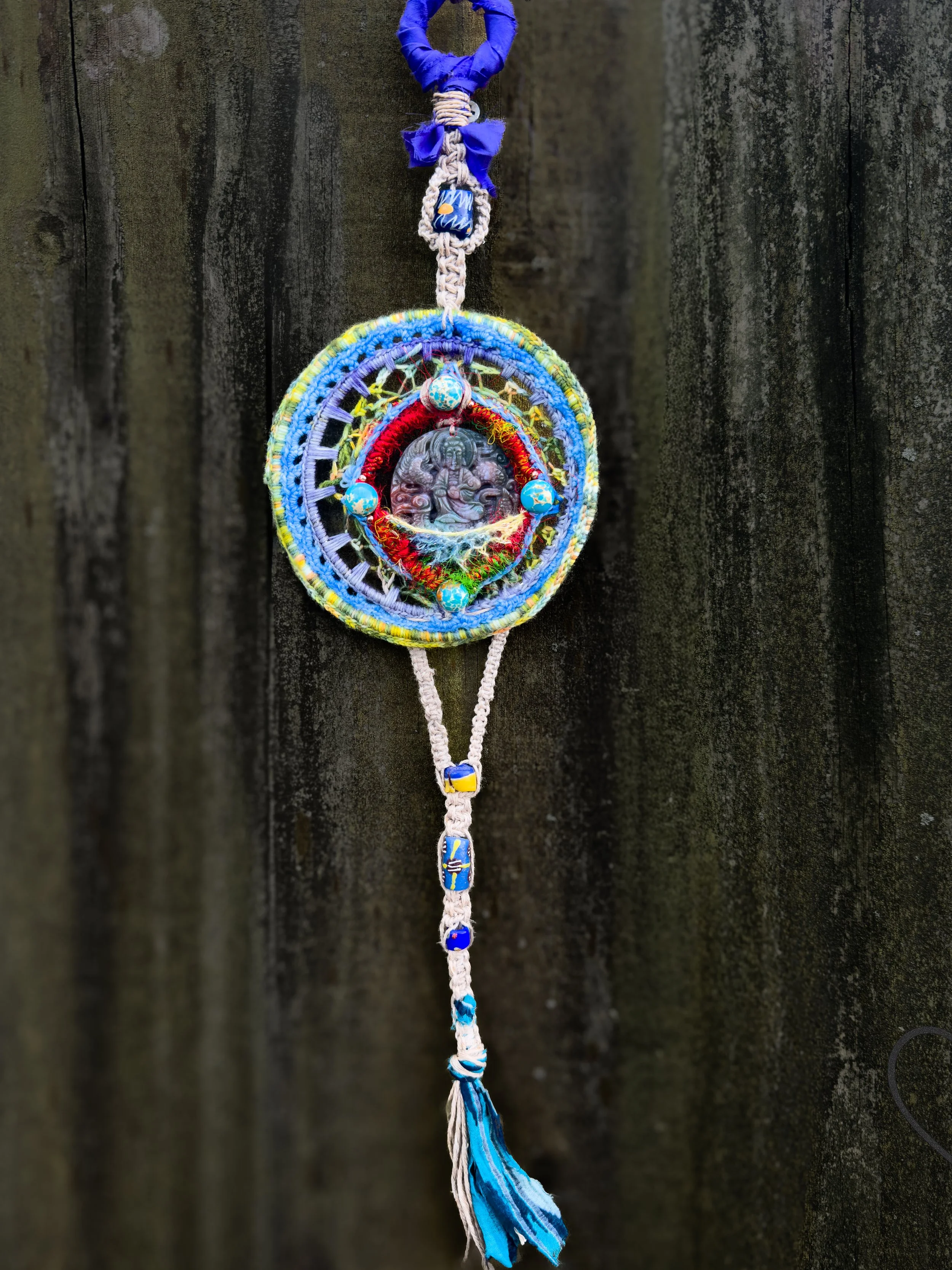 Handmade freeform crochet Dreamcatcher featuring a carved jade Buddha, painted howlite beads, silk, wool, and hemp. One-of-a-kind fiber art wall hanging.