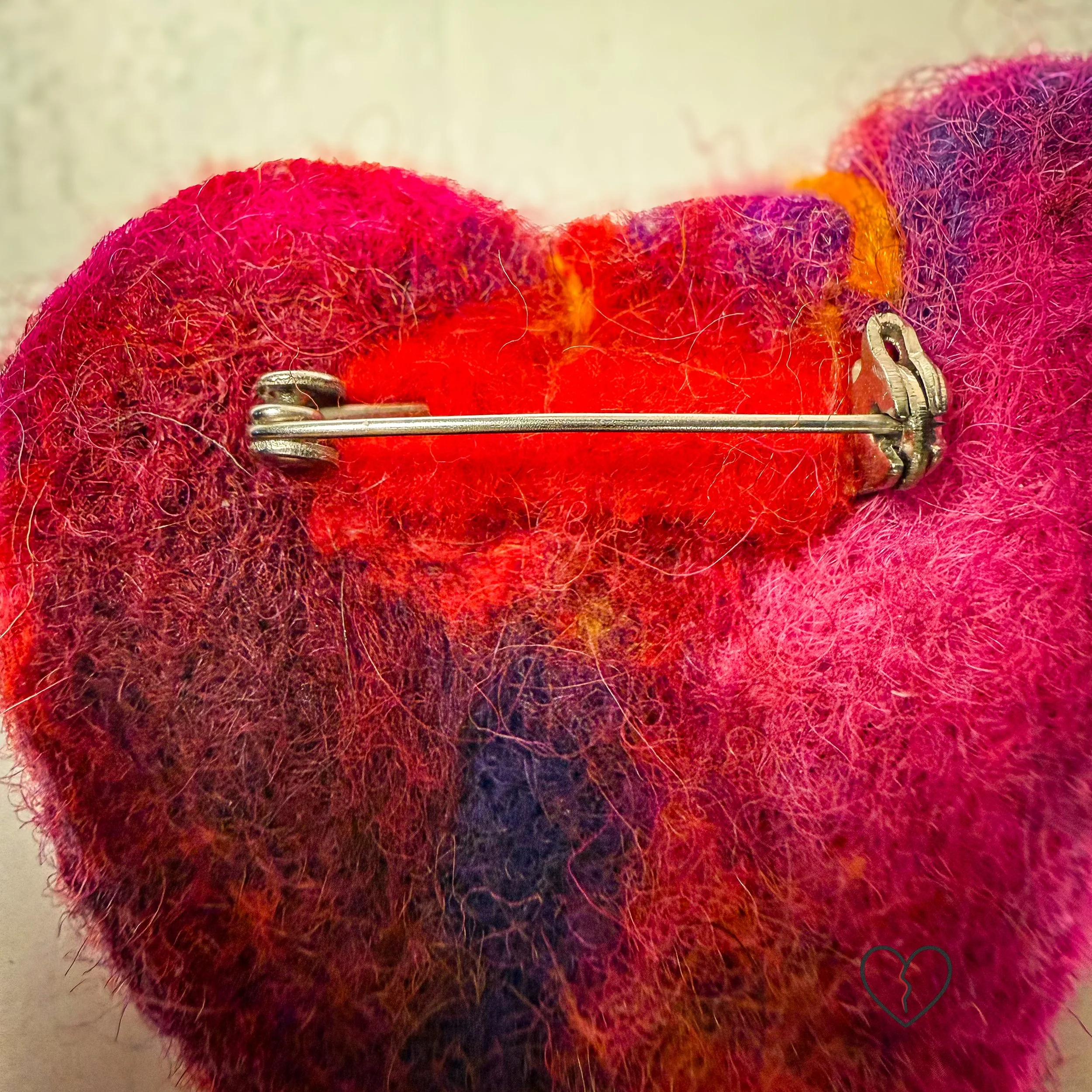 Handmade needle felted wool art pins arranged as a small collection, each approximately two inches square, featuring sculptural forms, layered fiber texture, and earthy tones.