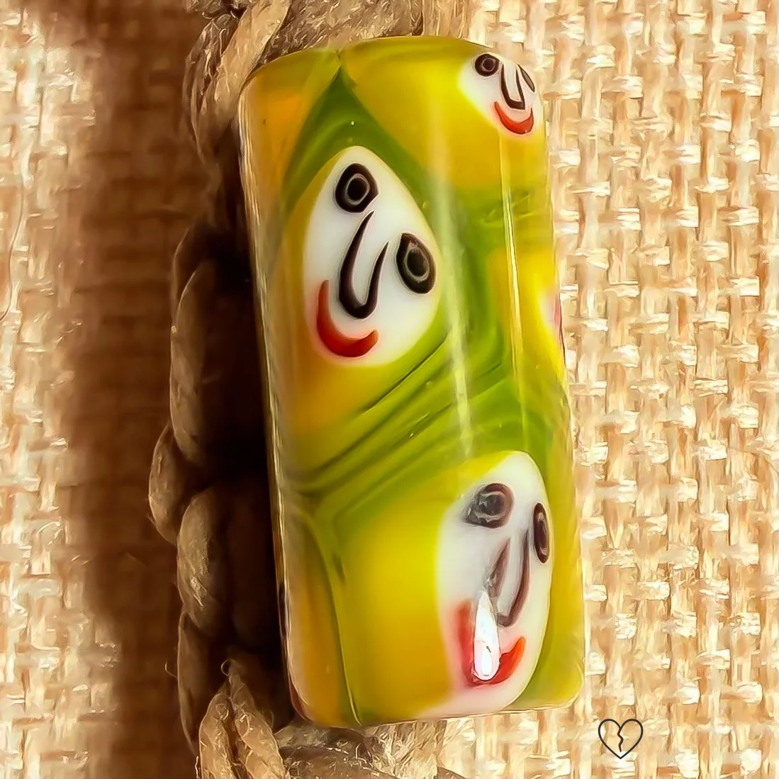 Lampwork glass bead with faces on fiber necklace cord