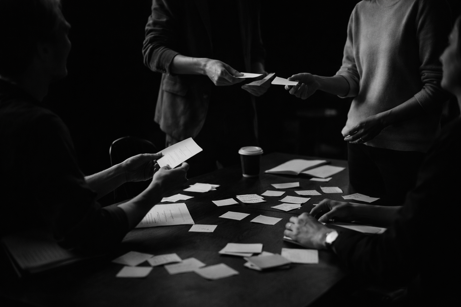 The Draft for Business. A group of people gathered around a table, working