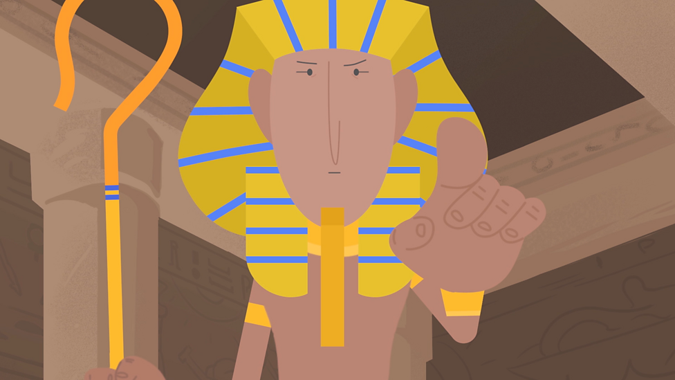 A cartoon depiction of an Egyptian pharaoh dressed as a lion, with a golden mane and a staff, pointing forward.
