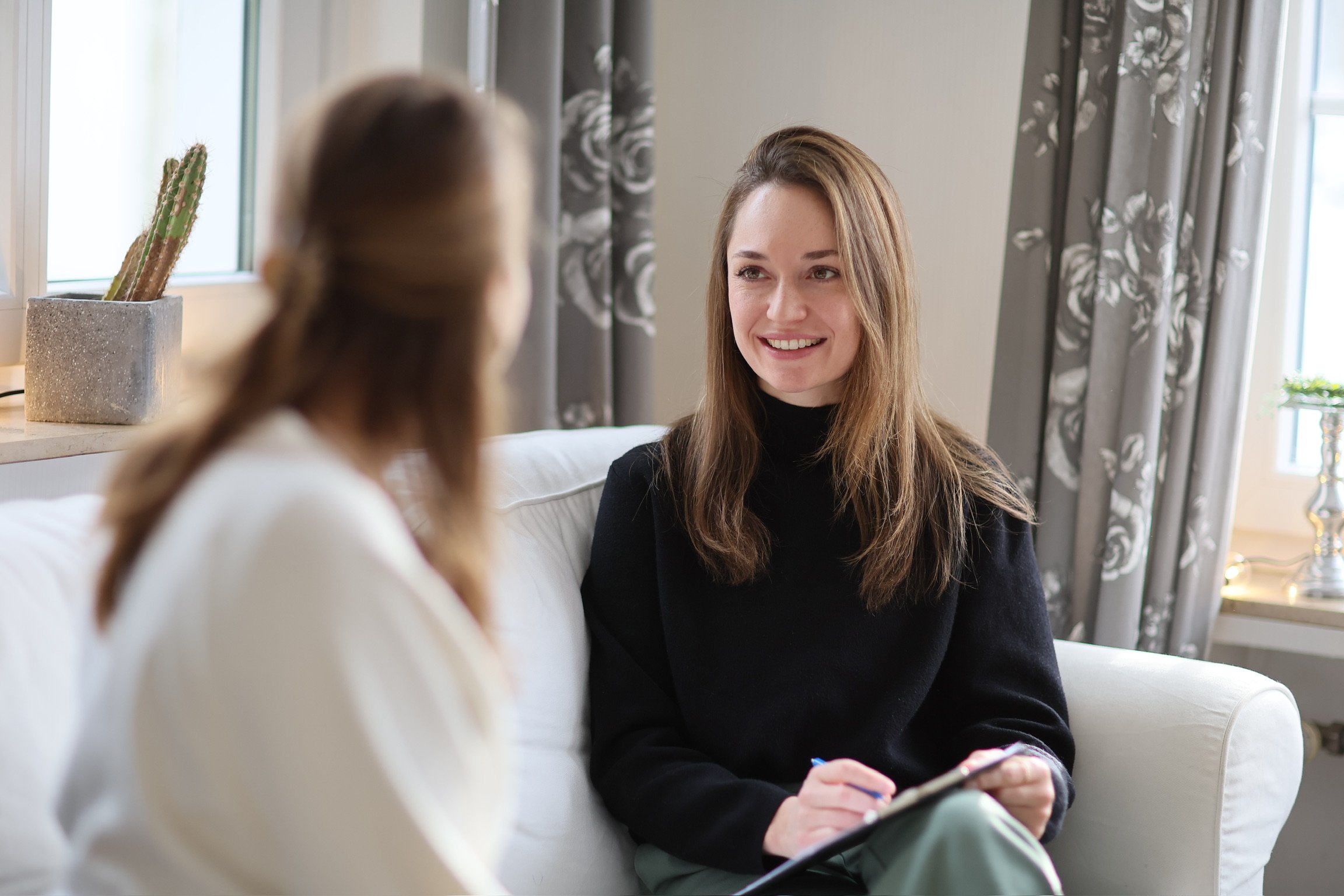 Psychologische Psychotherapeutin Denise Hecker im Gespräch mit einer Patientin in ihrer Praxis.