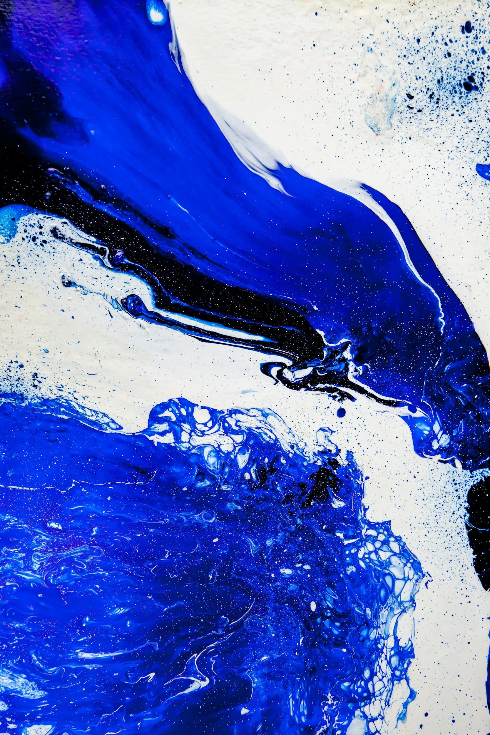 Abstract painting with swirls and splashes of blue, black, and white colors.