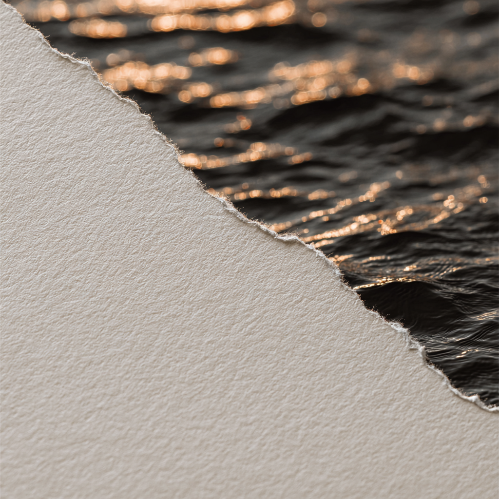 Close-up of torn paper layered over water at sunset with ripples