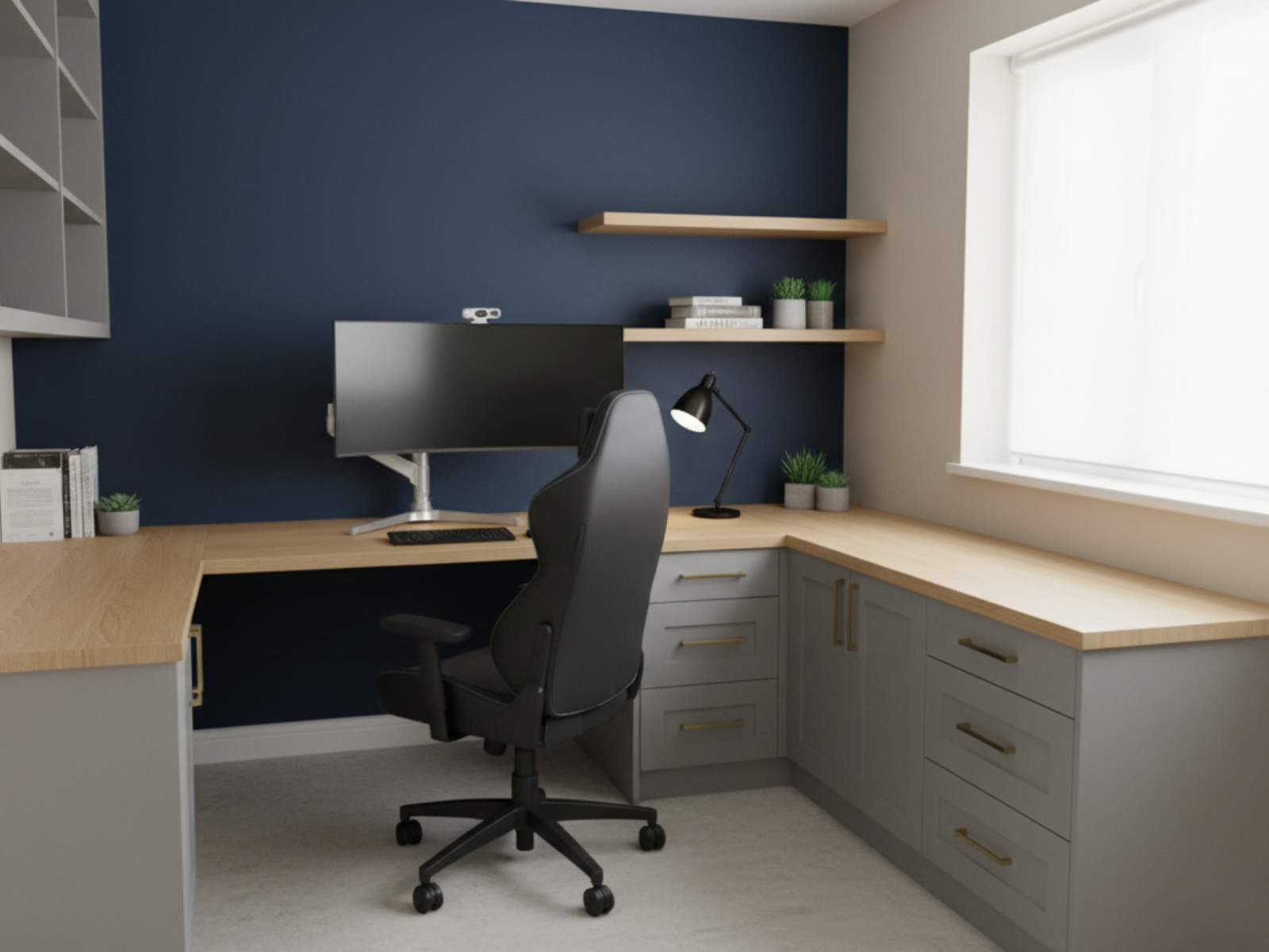 Modern home office with a corner desk, ergonomic office chair, navy accent wall, floating shelves, desktop monitor, desk lamp, potted plants, and books.