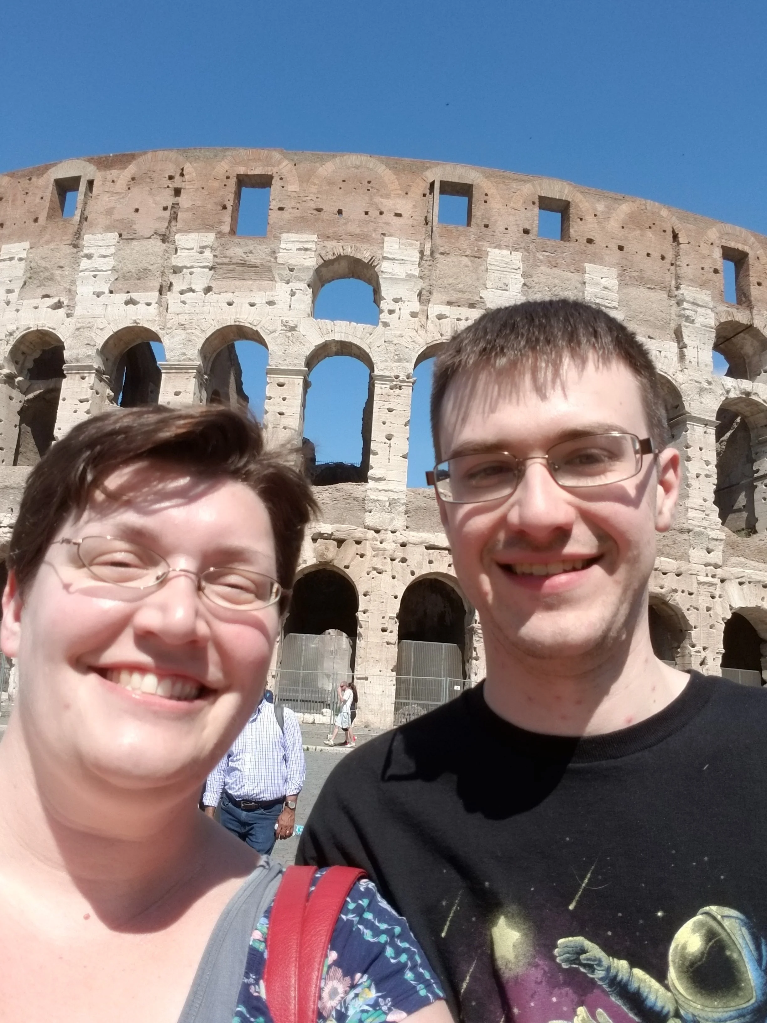 Stacy and husband selfie in front of the Colluseum in Rome