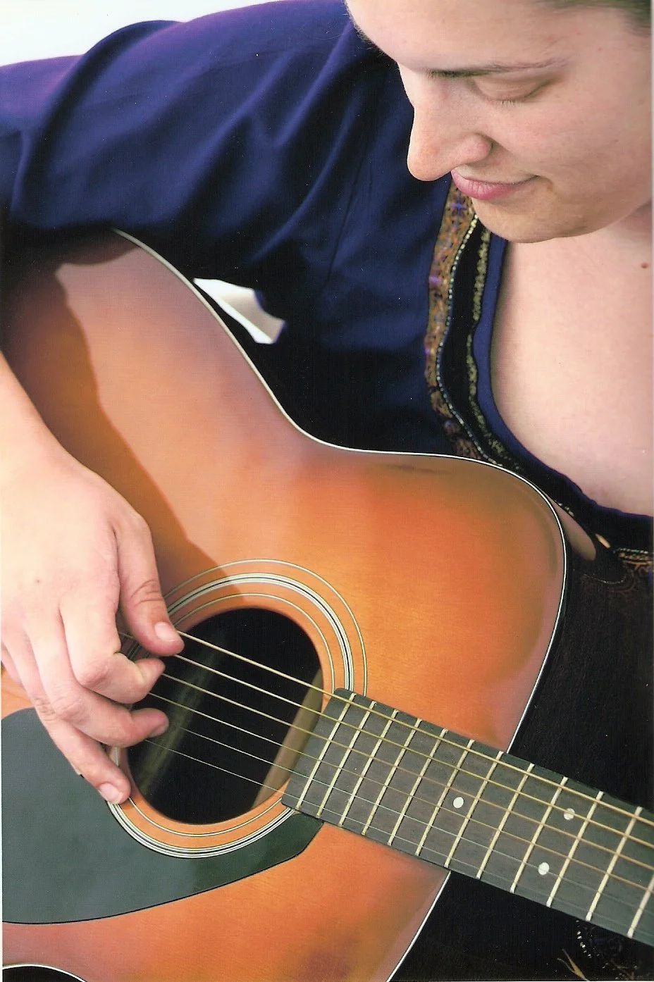 Photo of Stacy playing guitar