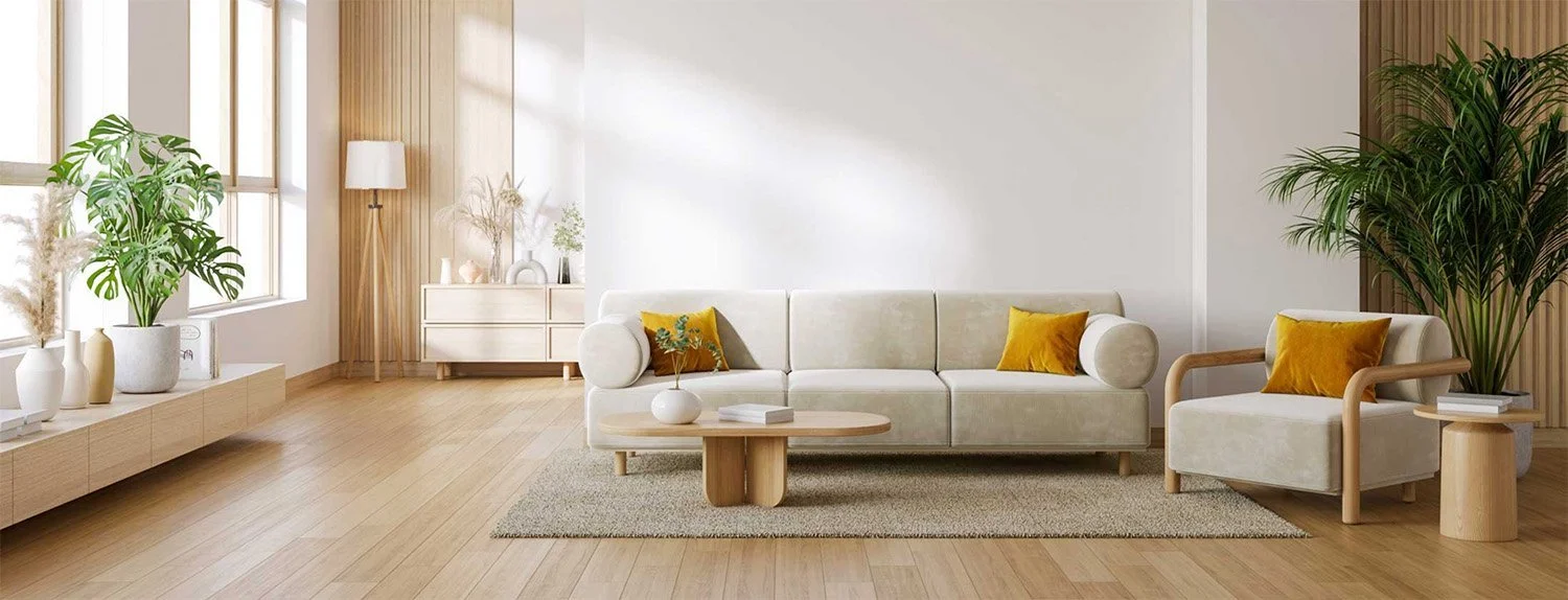 Bright sunlit vacation rental living room with beige modular sofa, golden yellow velvet pillows, natural wood furniture, and tropical plants, ready for guests after professional turnover cleaning in Phoenix