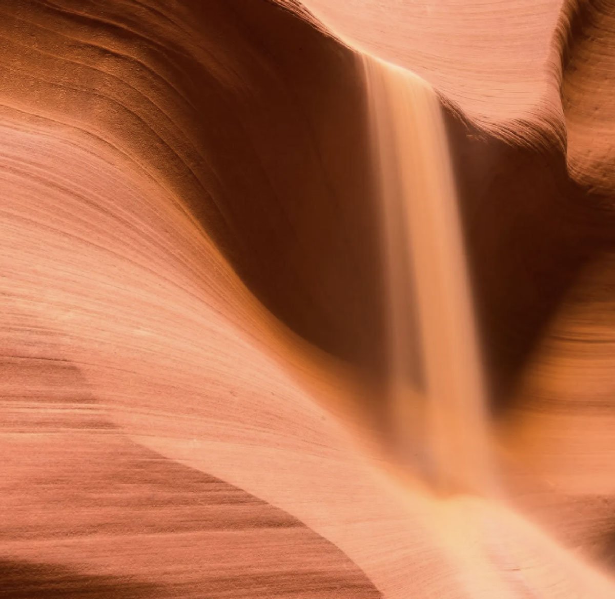 Smooth sandstone curves of Arizona slot canyon in warm orange and peach tones, representing local Arizona roots of AZ True Clean cleaning company