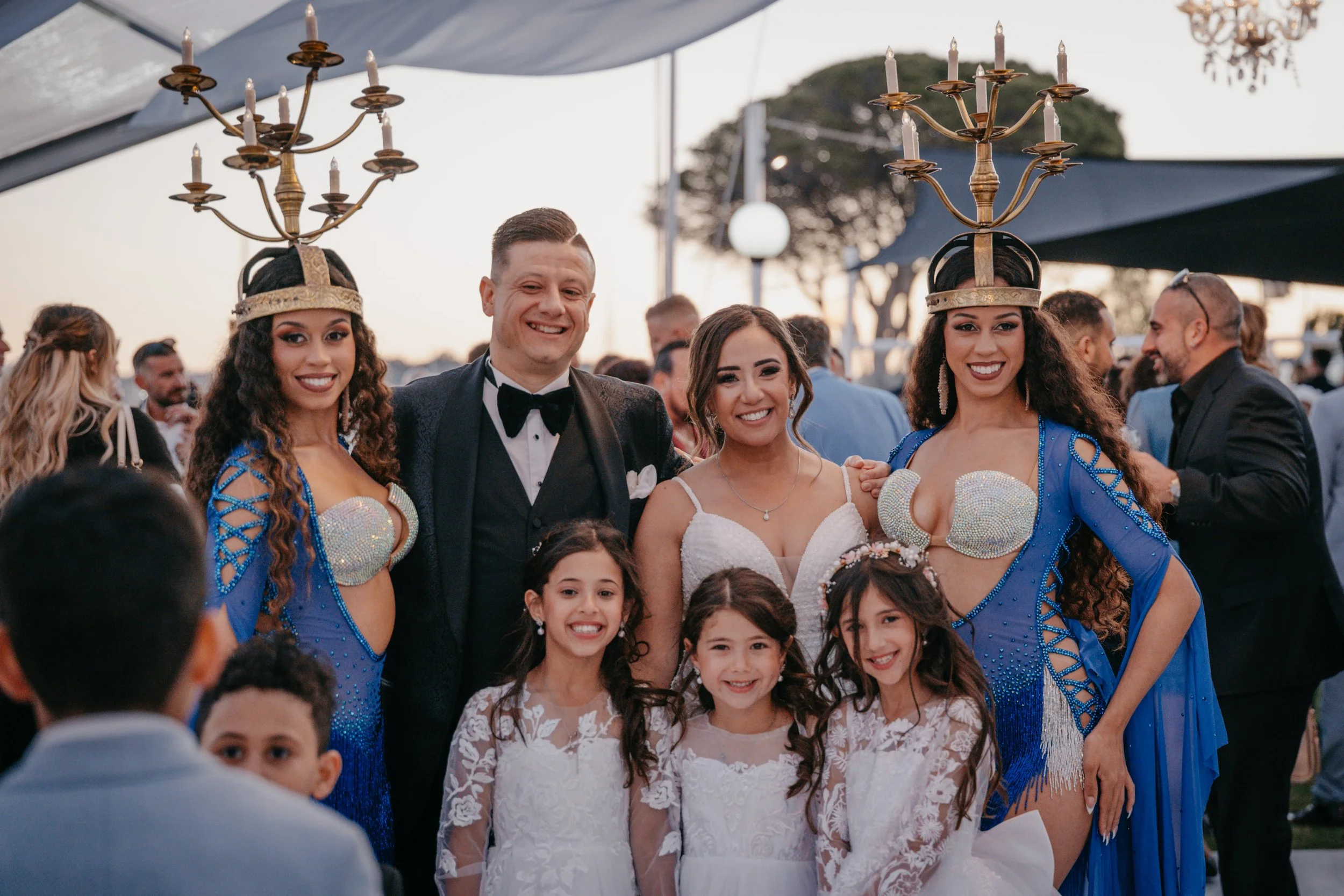 an image of a a bride and groom at their wedding with their three children and the 2 zarina bellydance twins.