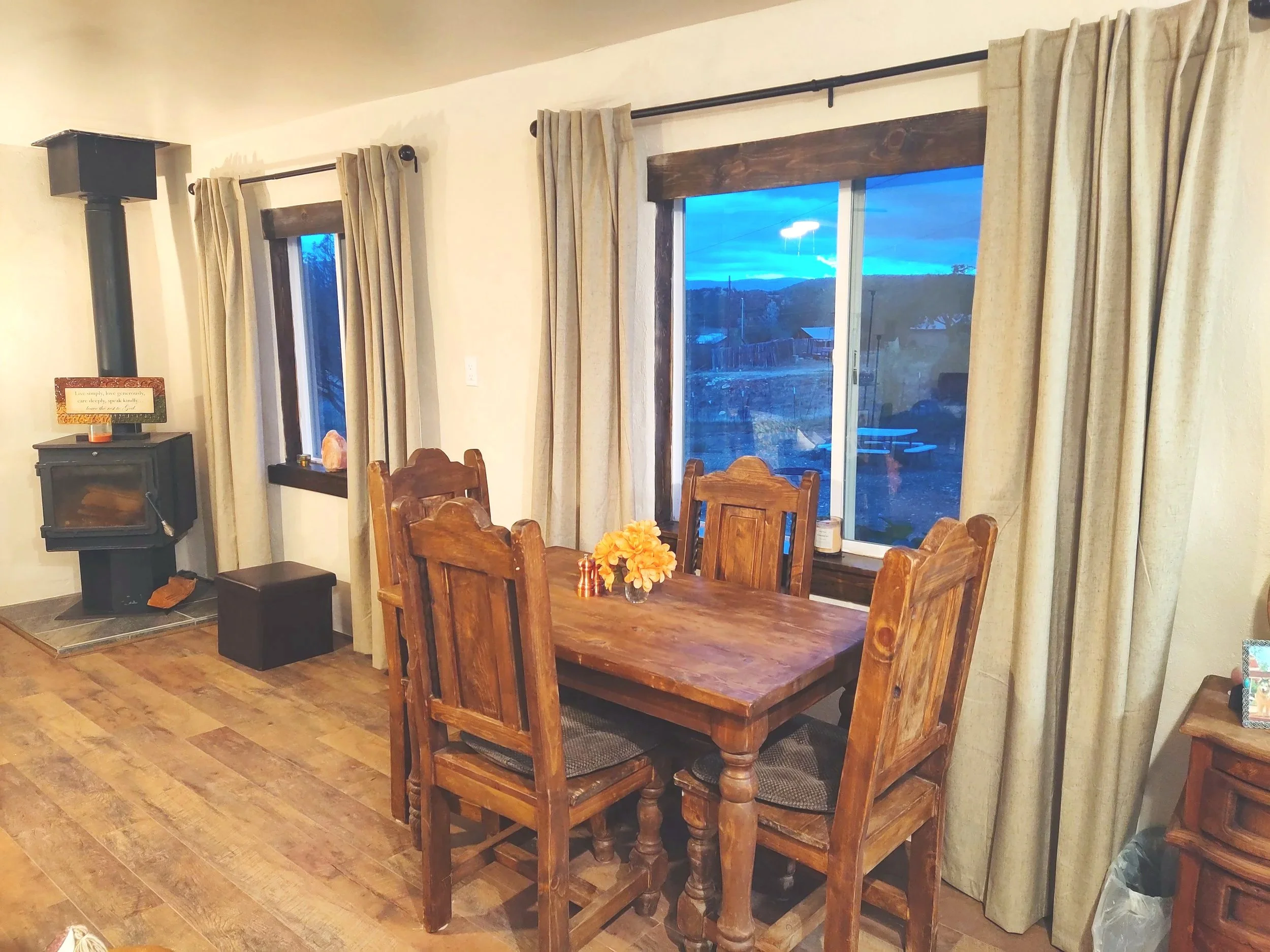 A cozy dining area in an adobe studio casita along in a village along the High Road to Taos