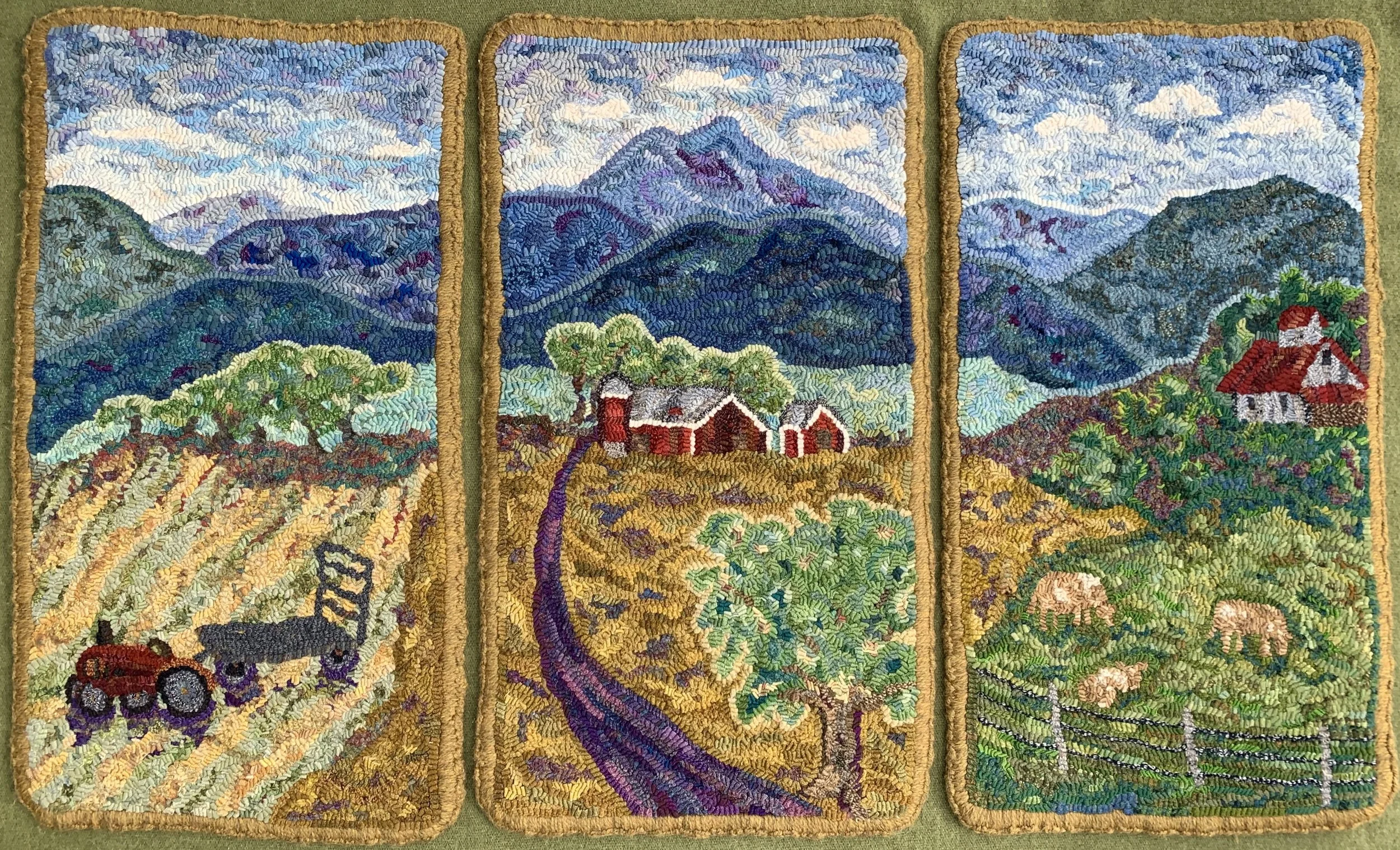 Embroidery depicting three panels of a rural landscape with mountains, trees, farmhouses, a tractor, and fields, with a sky filled with clouds.