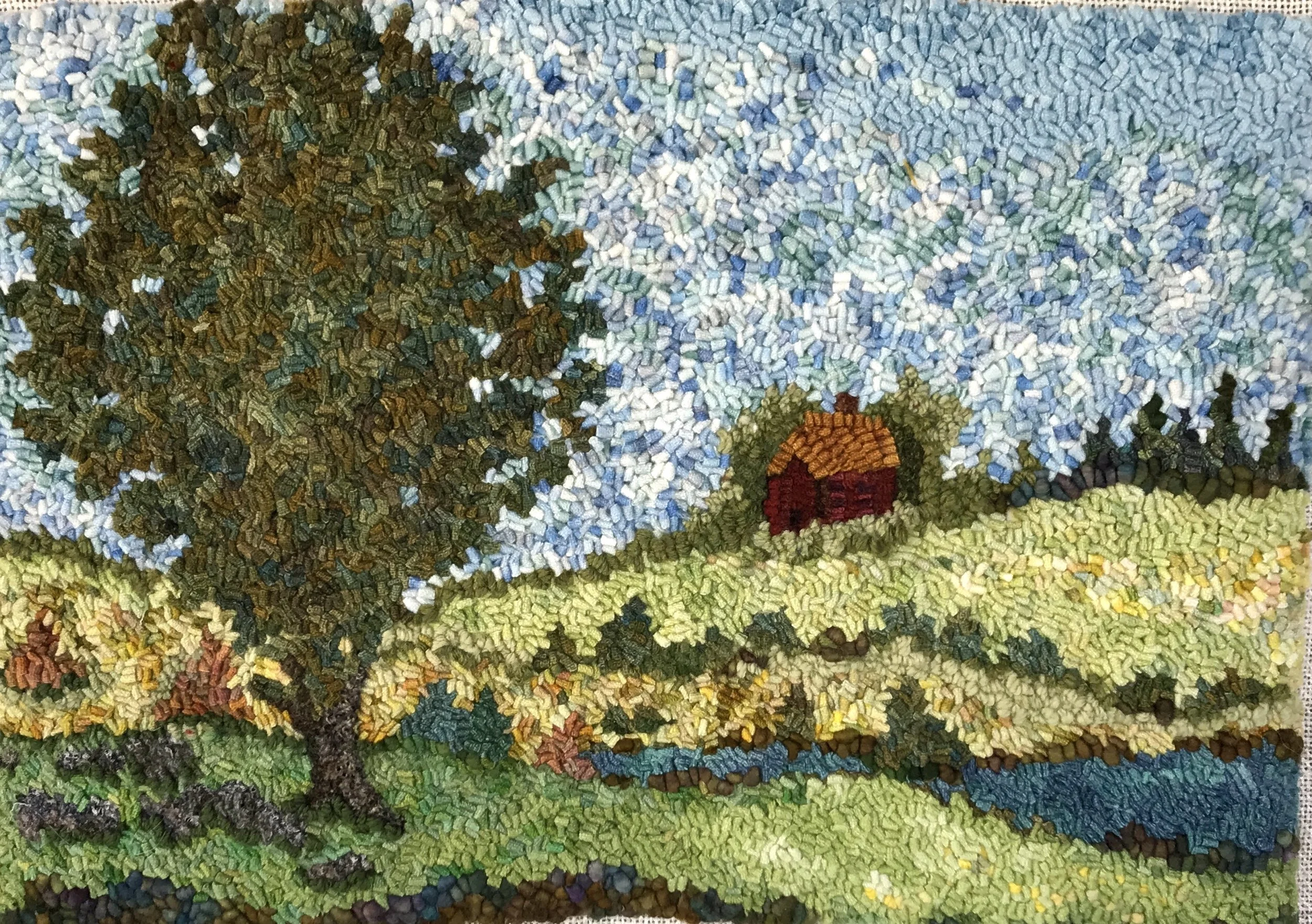 A textured mosaic art depicting a landscape with a large tree on the left, green grass, a small red house with a brown roof, and a blue sky with clouds.