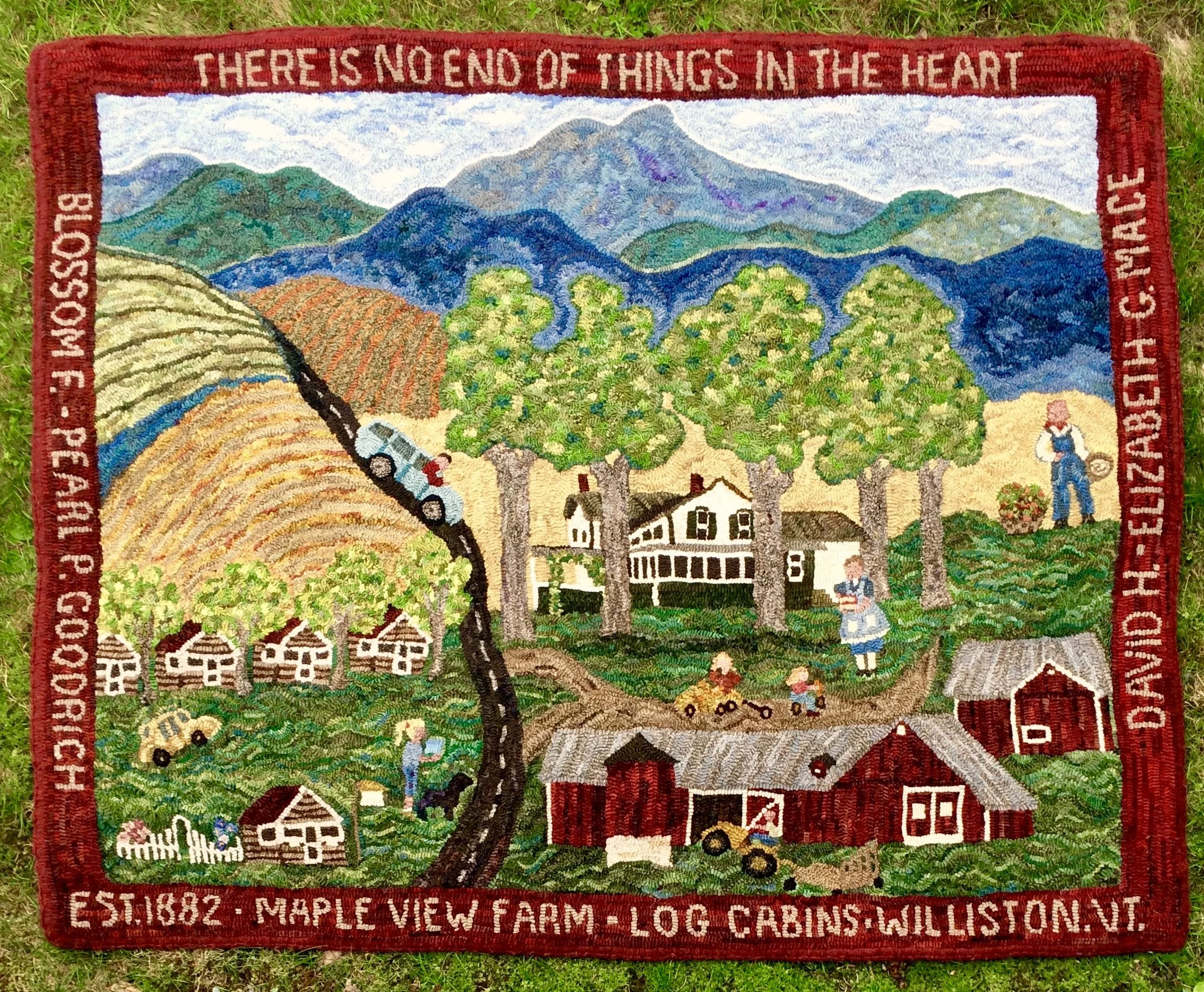 Colorful embroidered tapestry of Maple View Farm in Williston, Vermont, depicting mountains, trees, farmhouses, a red barn, a tractor, a pickup truck, children playing, and a woman with a basket, with the quote 'There is no end of things in the heart' at the top.