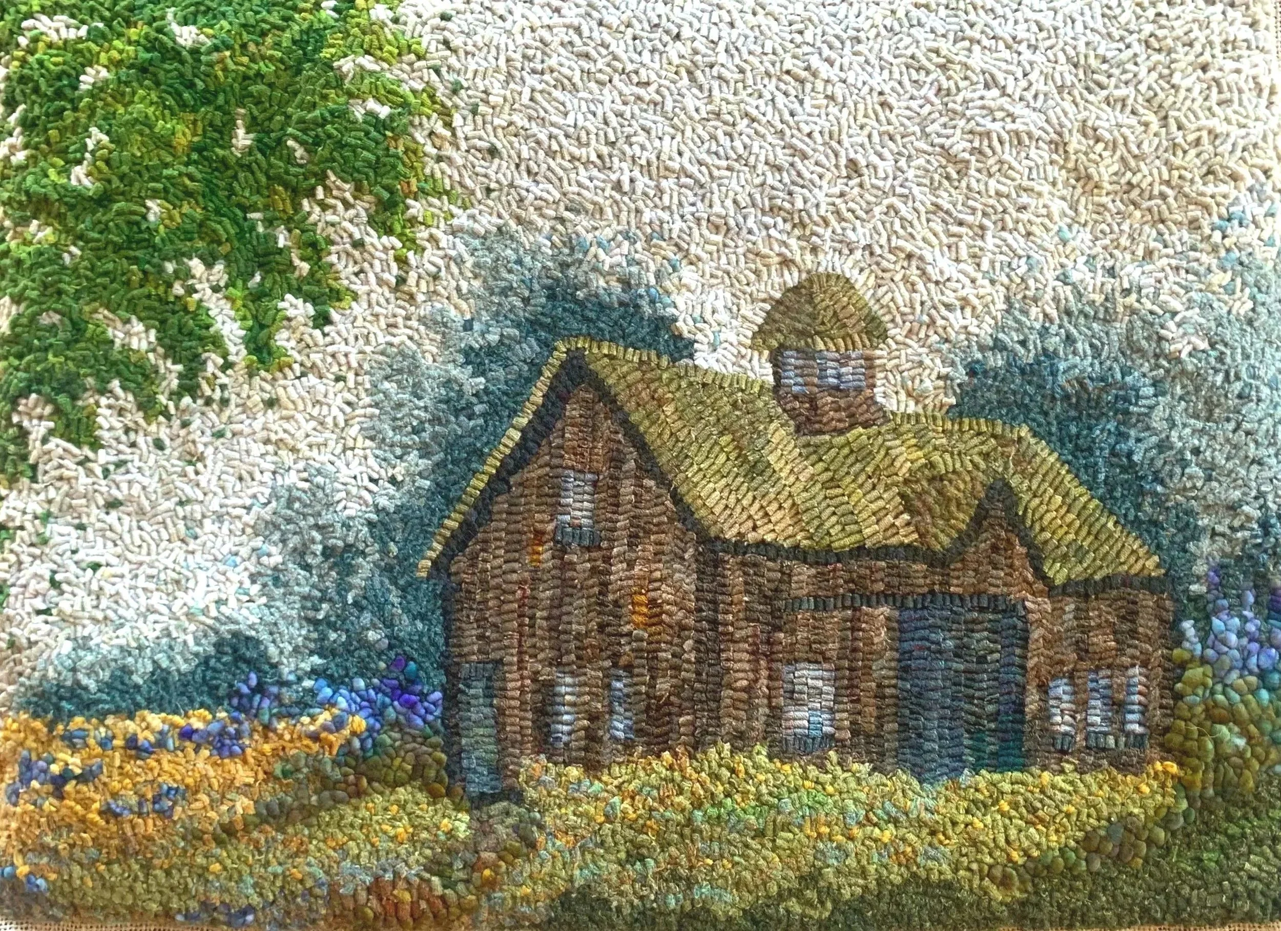 A detailed embroidered artwork depicting a large, old house with a tower and a dome, surrounded by trees and colorful flowers under a textured sky.