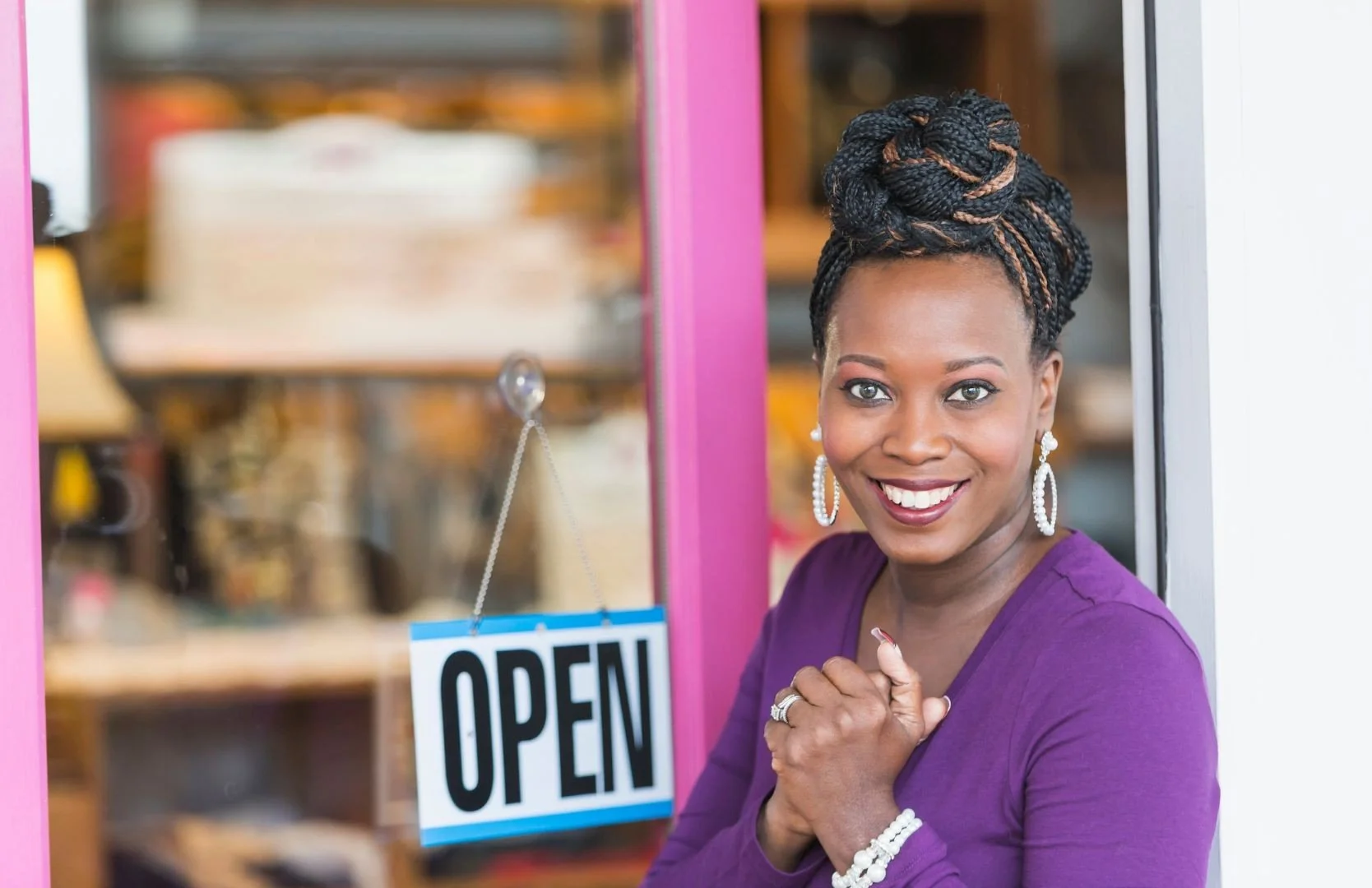 Business owner with a Open sign  on the door