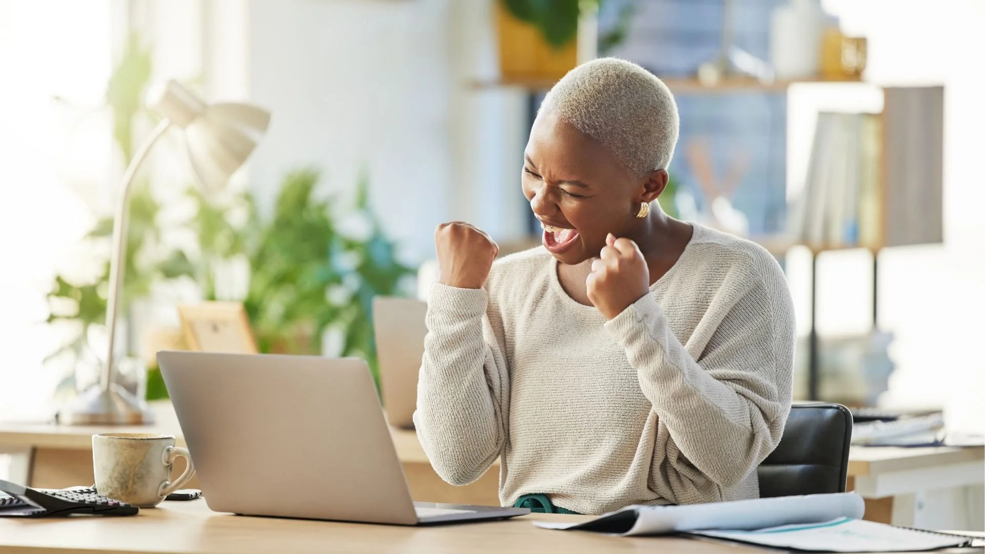 Woman celebrating success by pumping fists